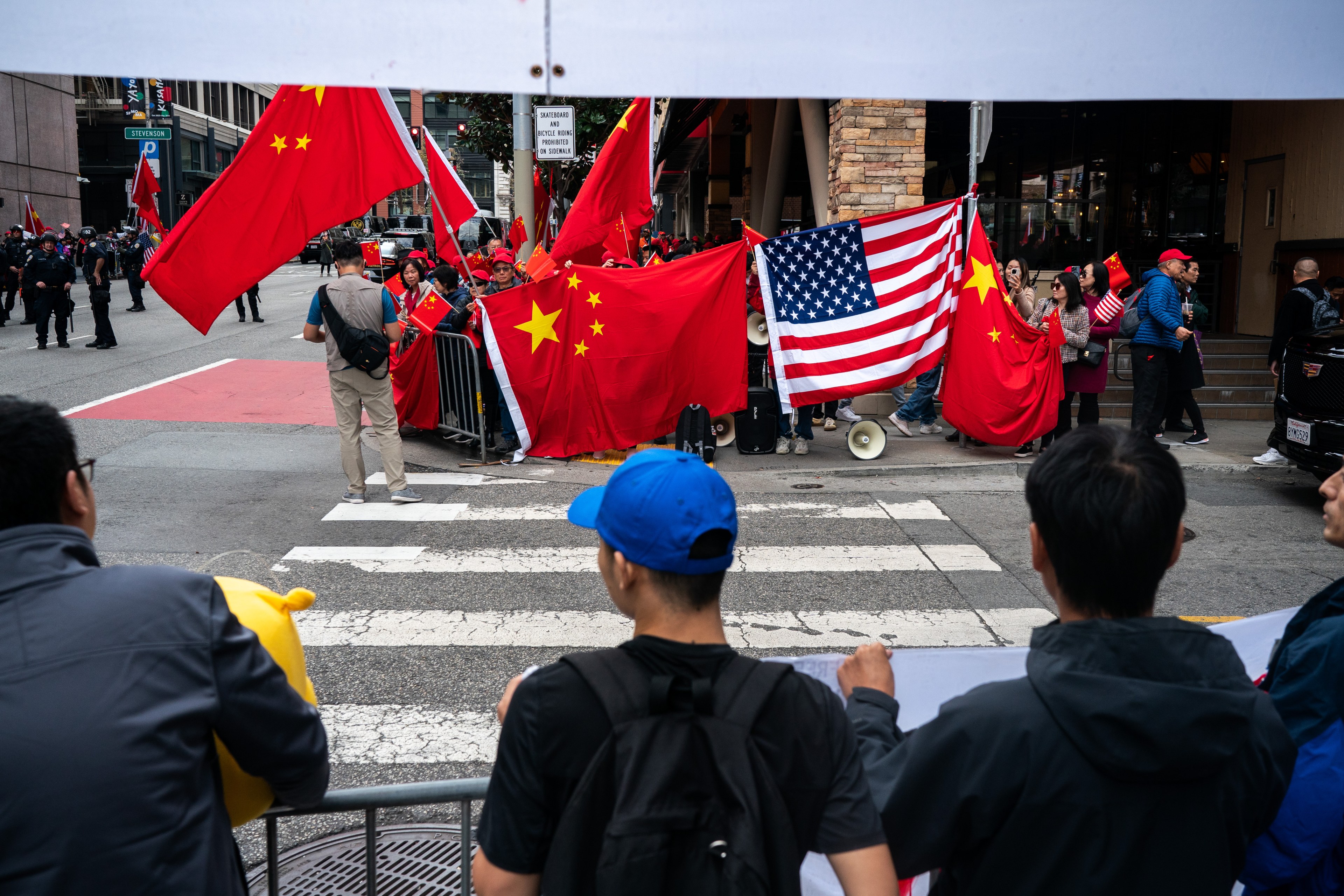 Large American and Chinese flags are seen during a protest in San Francisco.