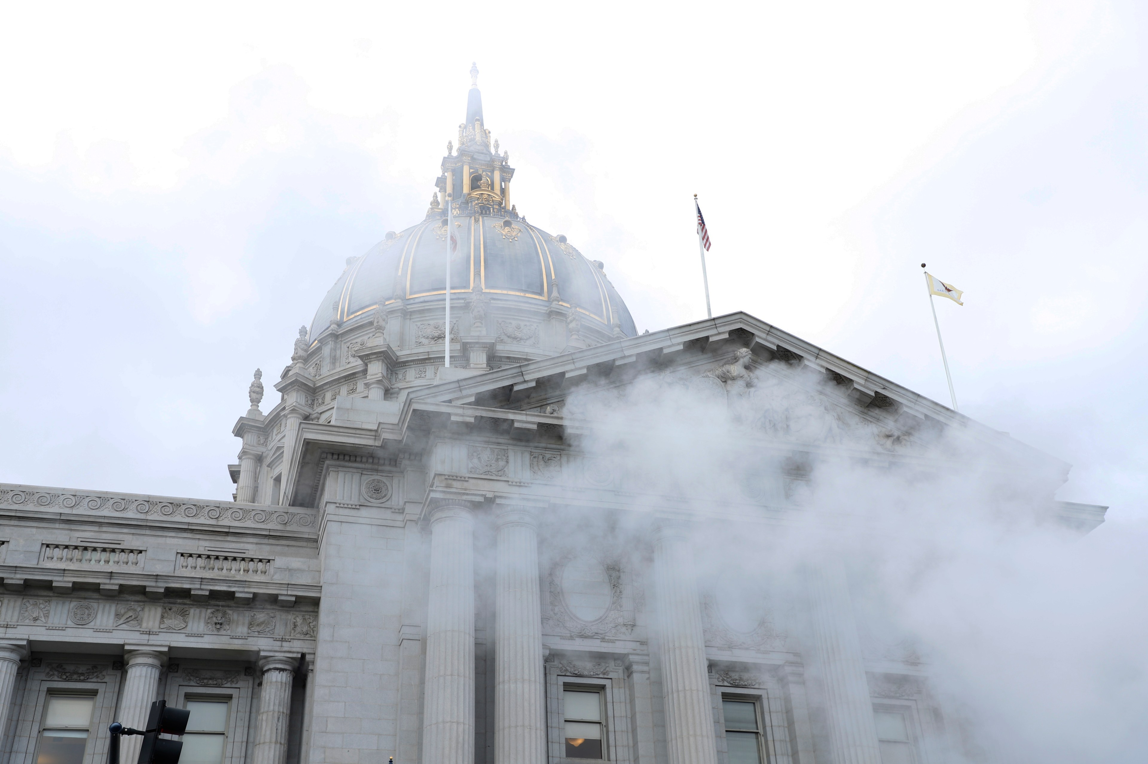Steam rises from the bottom of the photo with San Francisco's City Hall in the background