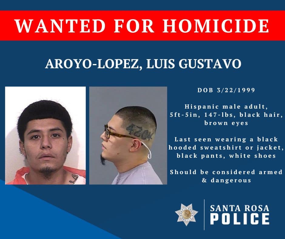 A "Wanted for Homocide" poster has two inset mugshots of Luis Gustavo Aroyo-Lopez. In the far left image, he looks directly at the camera and sports a full head of hair. In the next image, he is pictured in profile, facing left, with his head shaved, exposing a "420" tattoo. The text describes him as "Hispanic male adult, 5-foot-5-inches, 147 pounds, black hair, brown eyes. Last seen wearing a black hooded sweatshirt or jacket, black pants, white shoes."