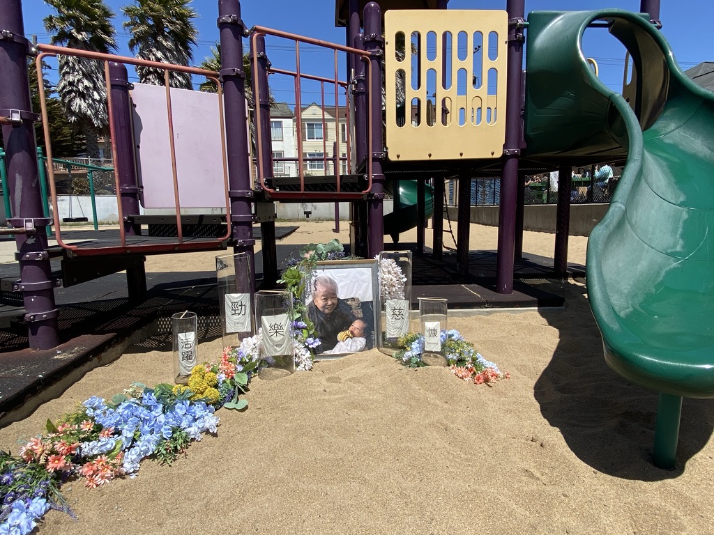 Flowers and a photo of Yik Oi Huang are placed at the playground where she was assaulted.