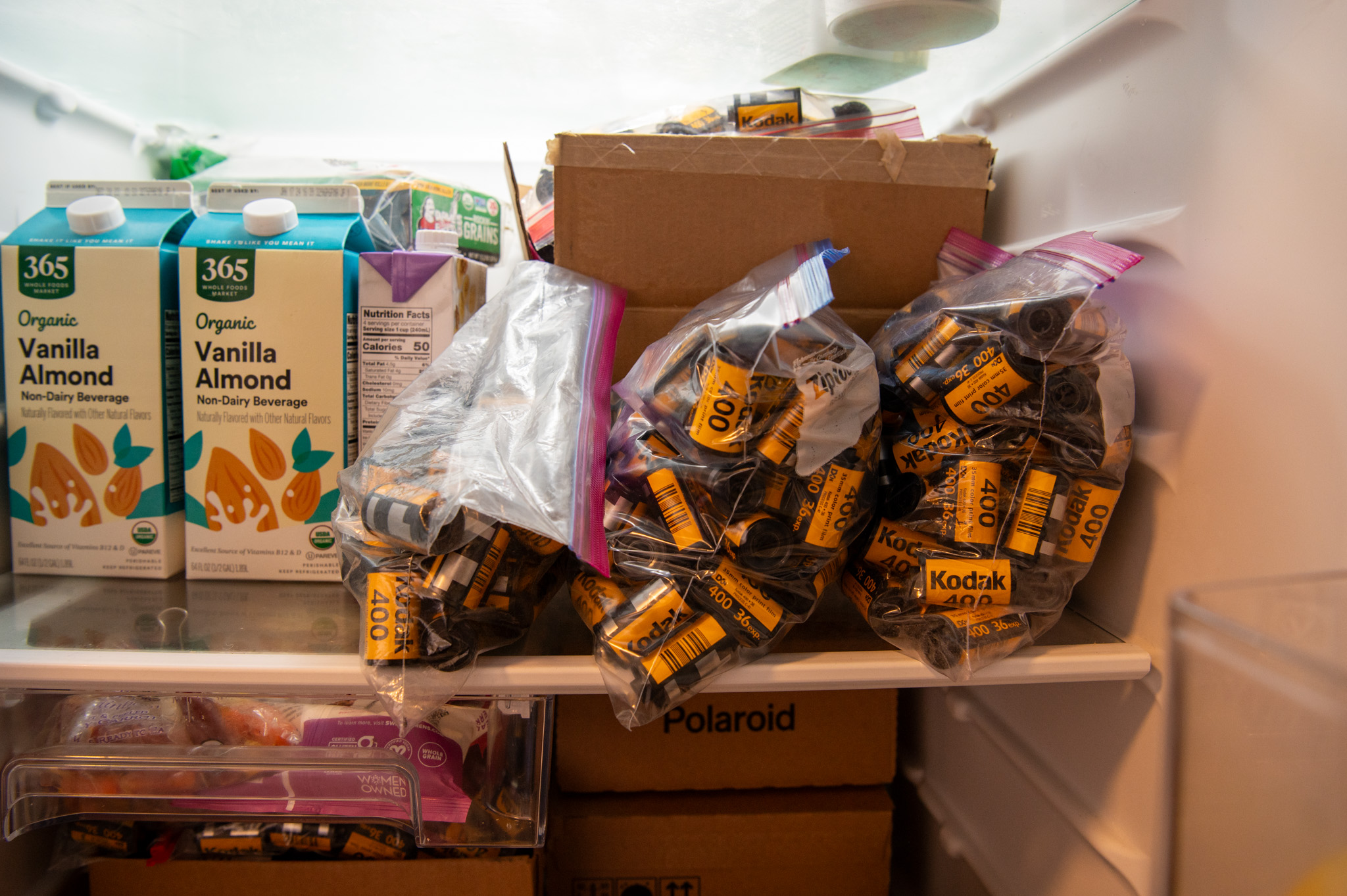 Plastic bags and boxes of undeveloped film sit in Jake Ricker’s fridge in his Outer Richmond apartment in San Francisco on Monday, Dec. 12, 2023. 