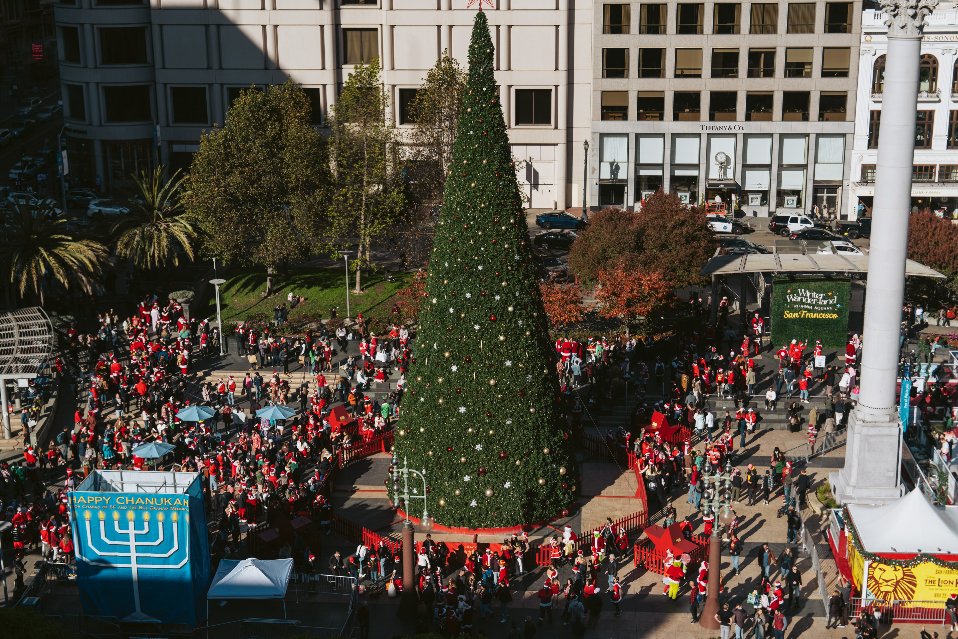 An overhead view of the Christmas tree and Chanukah menorah in Union Square during SantaCon.