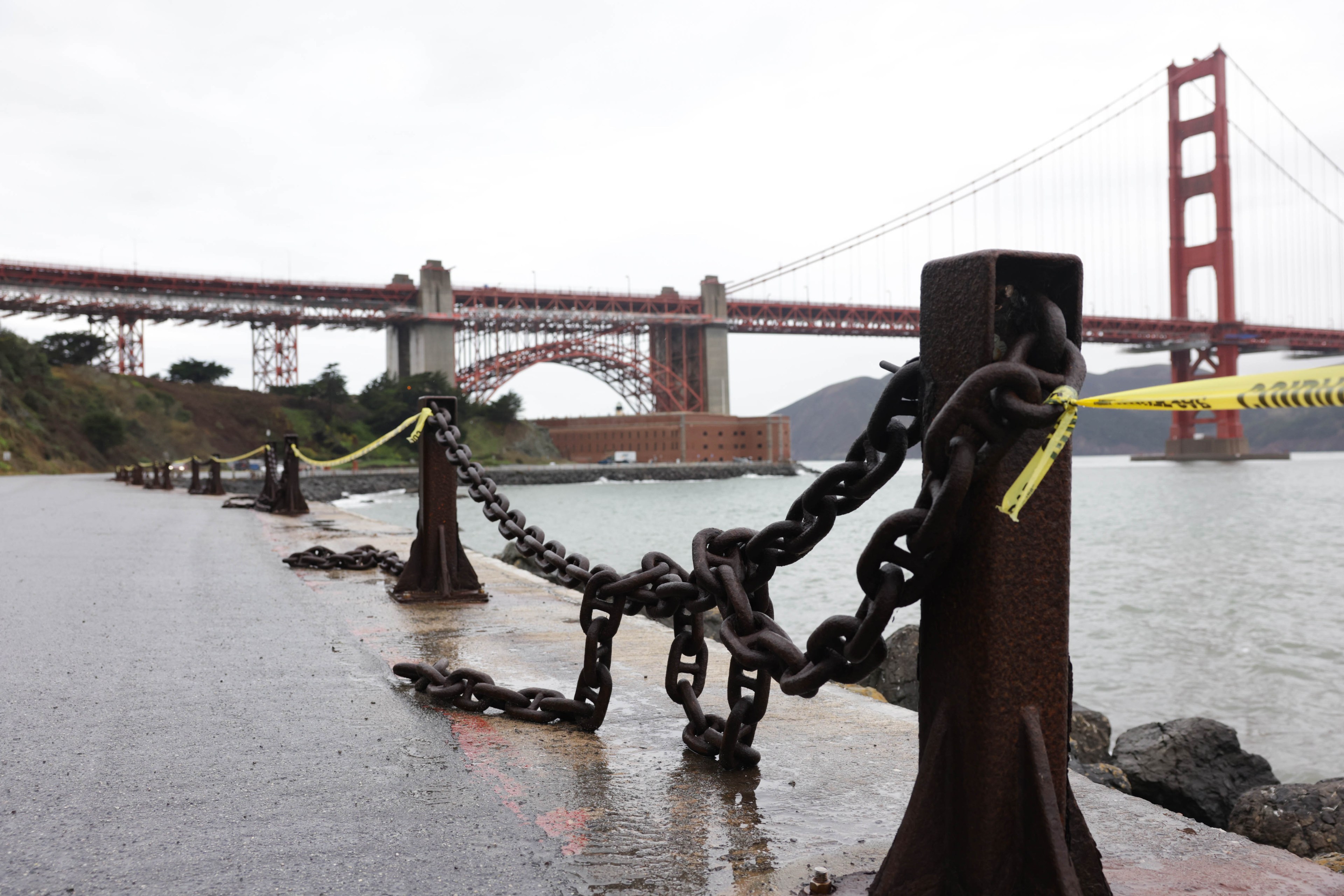 A low angle photo of metal chains that act as guard rails near the Golden Gate Bridge.