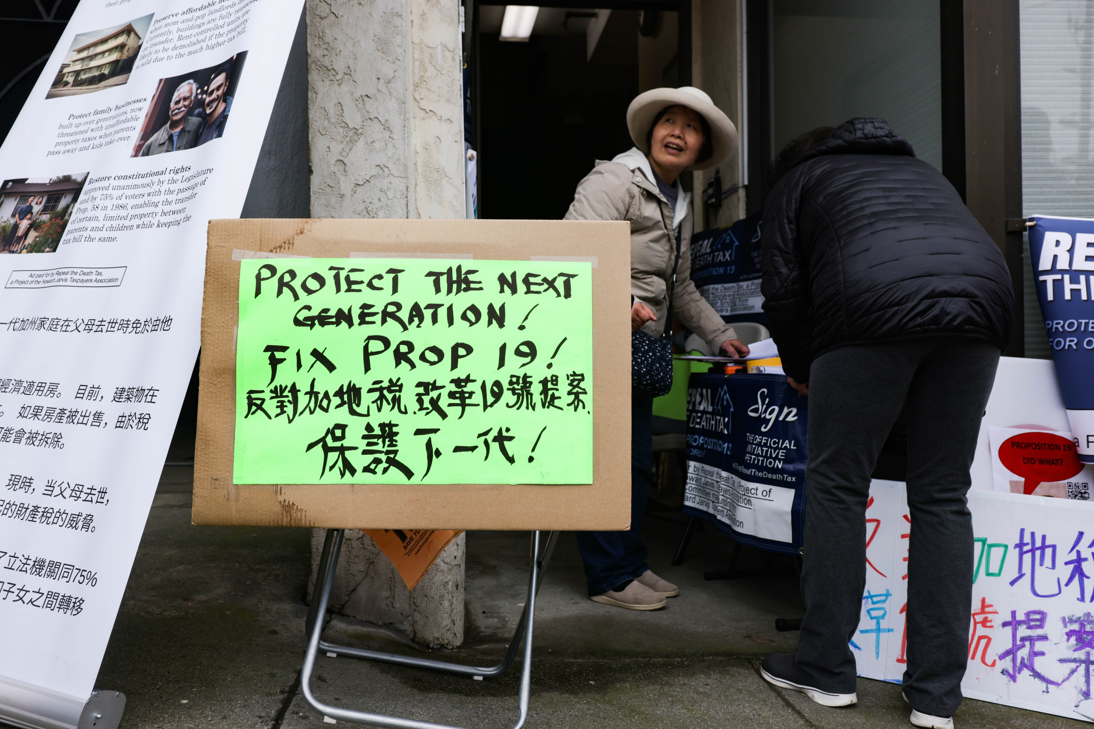 A sign displaying English and Chinese text calling for the repeal of Prop. 19.