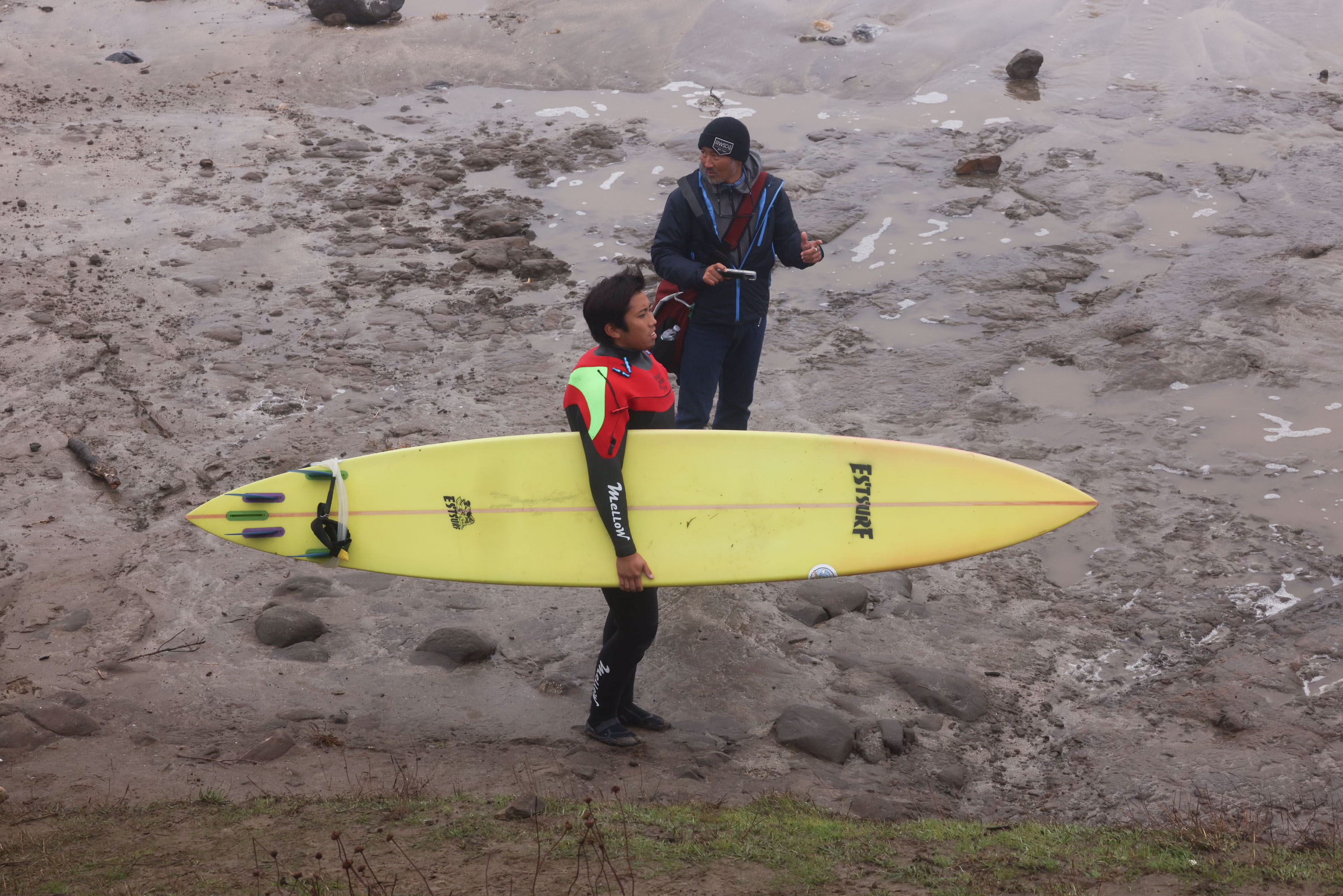 A surfer prepares to enter the waters at Mavericks Beach. 