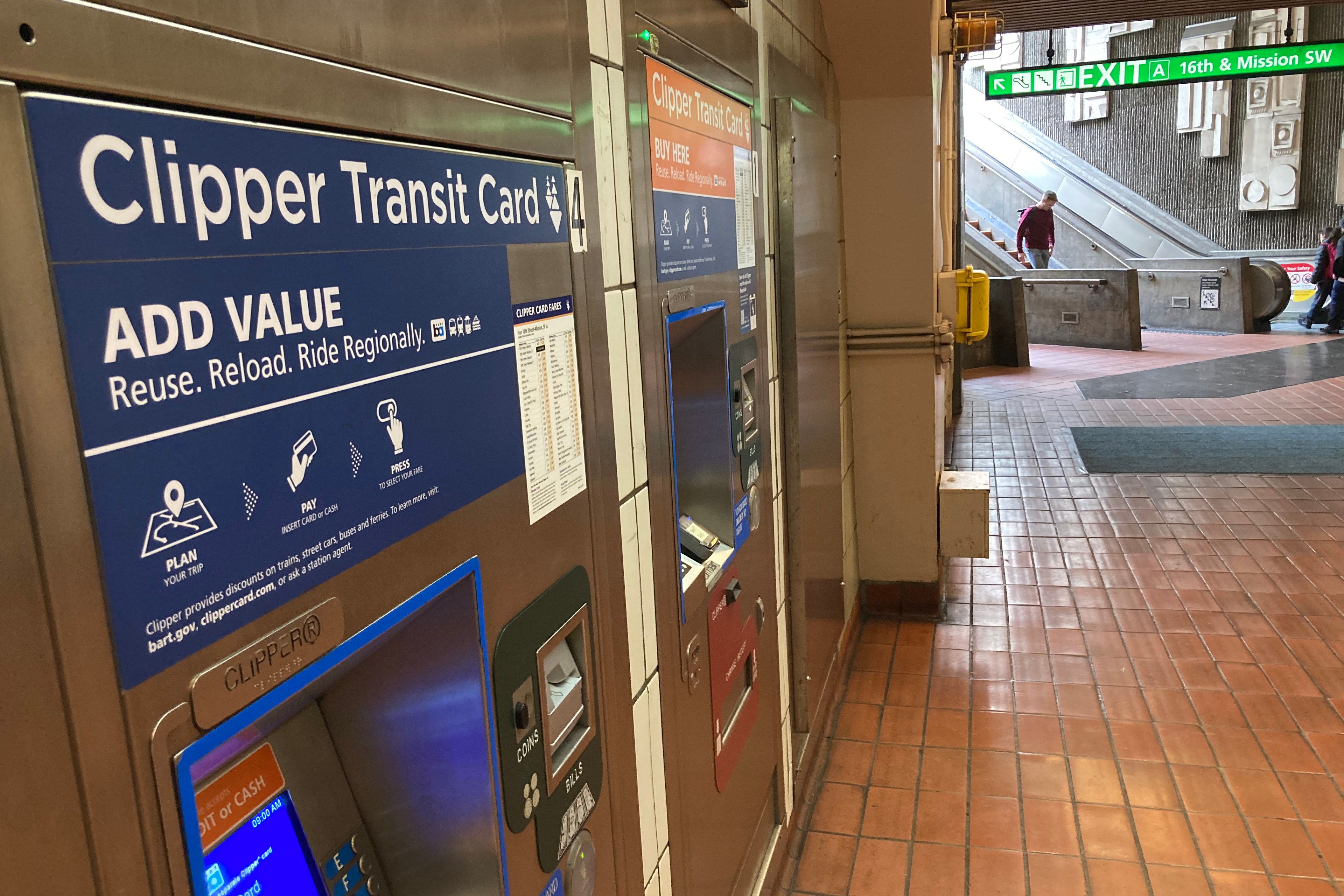 BART riders walk passed a Clipper Transit Card kiosk at 16th Street and Mission station .
