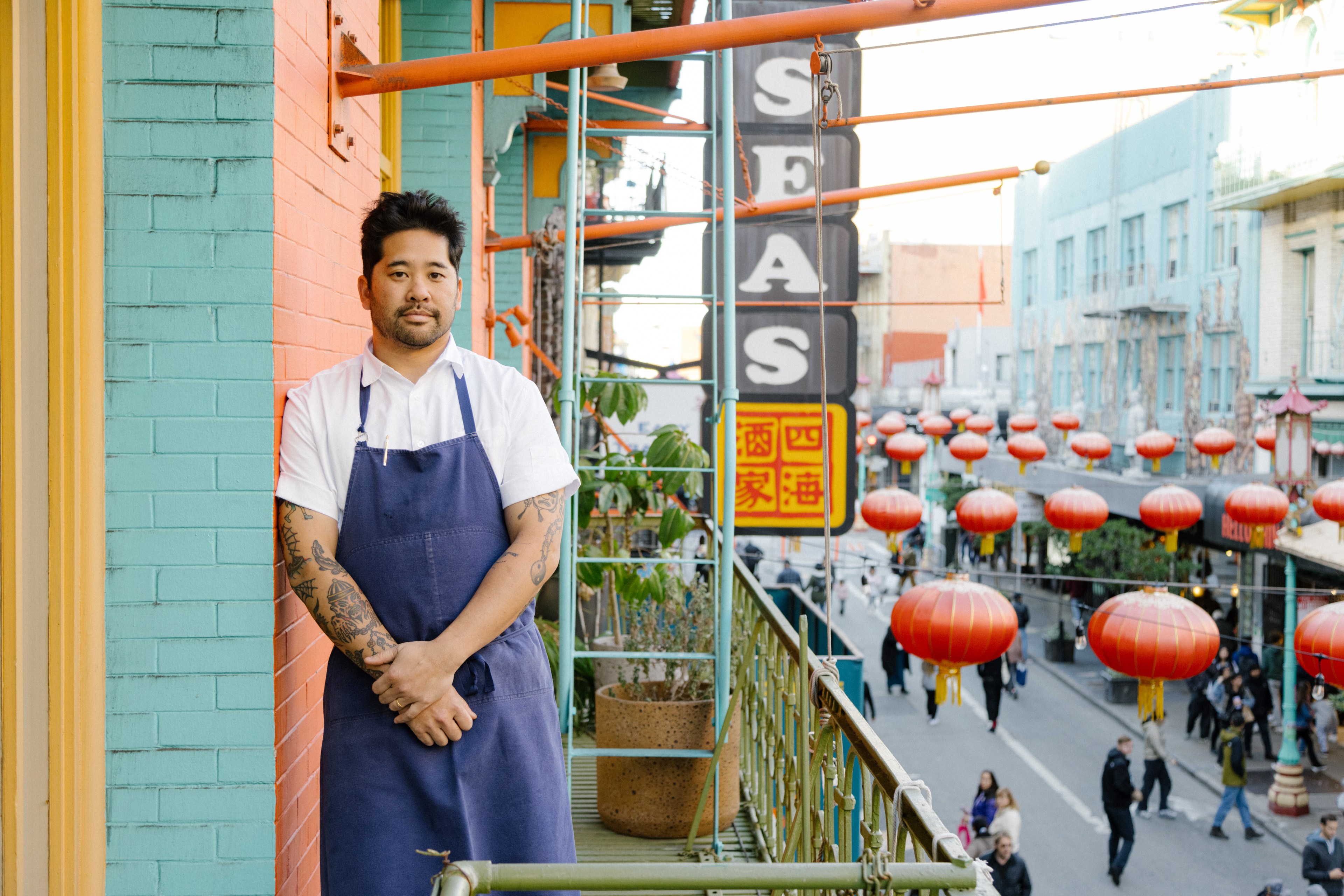 Brandon Jew, executive chef and owner of Mister Jiu's, stands on the balcony of the restaurant in San Francisco