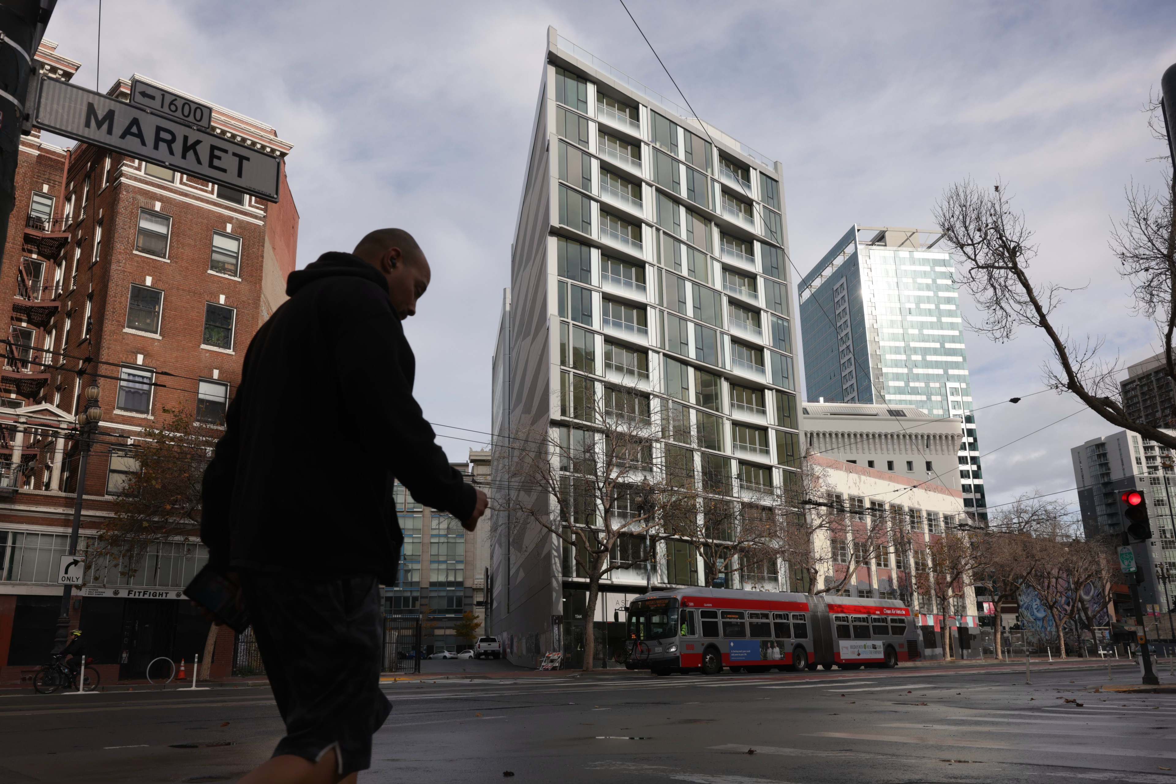 A person walks past a condo building on Market Street.