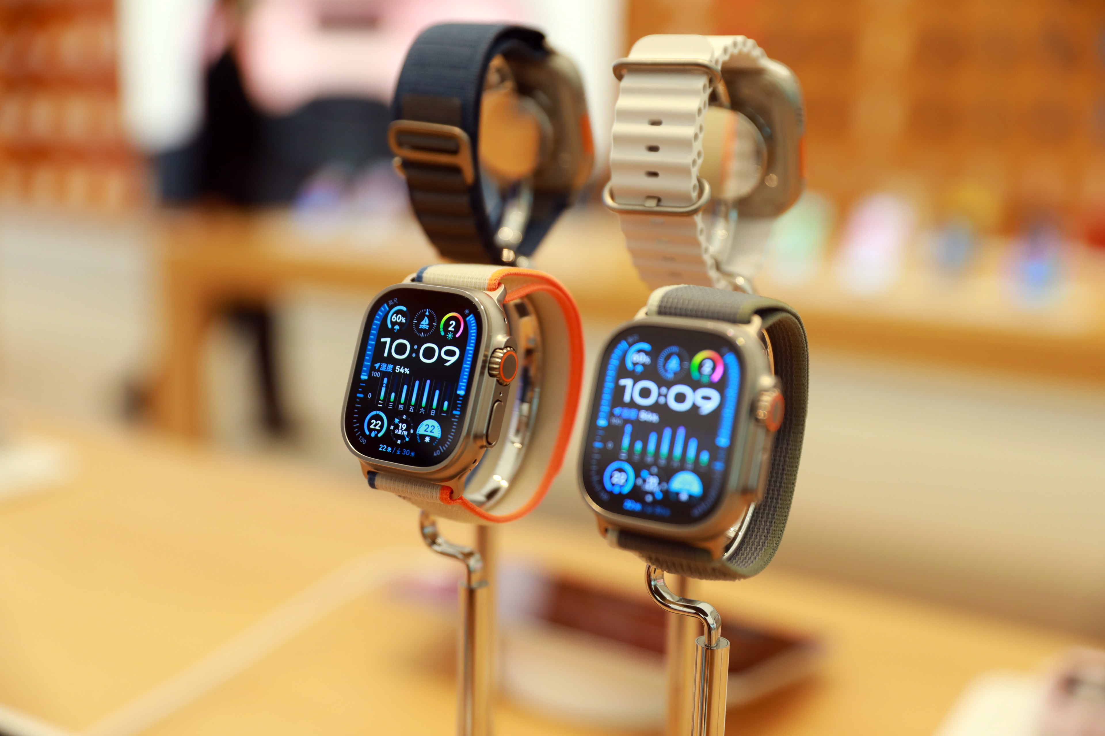 Four Apple watches—two with their faces visible—are on display