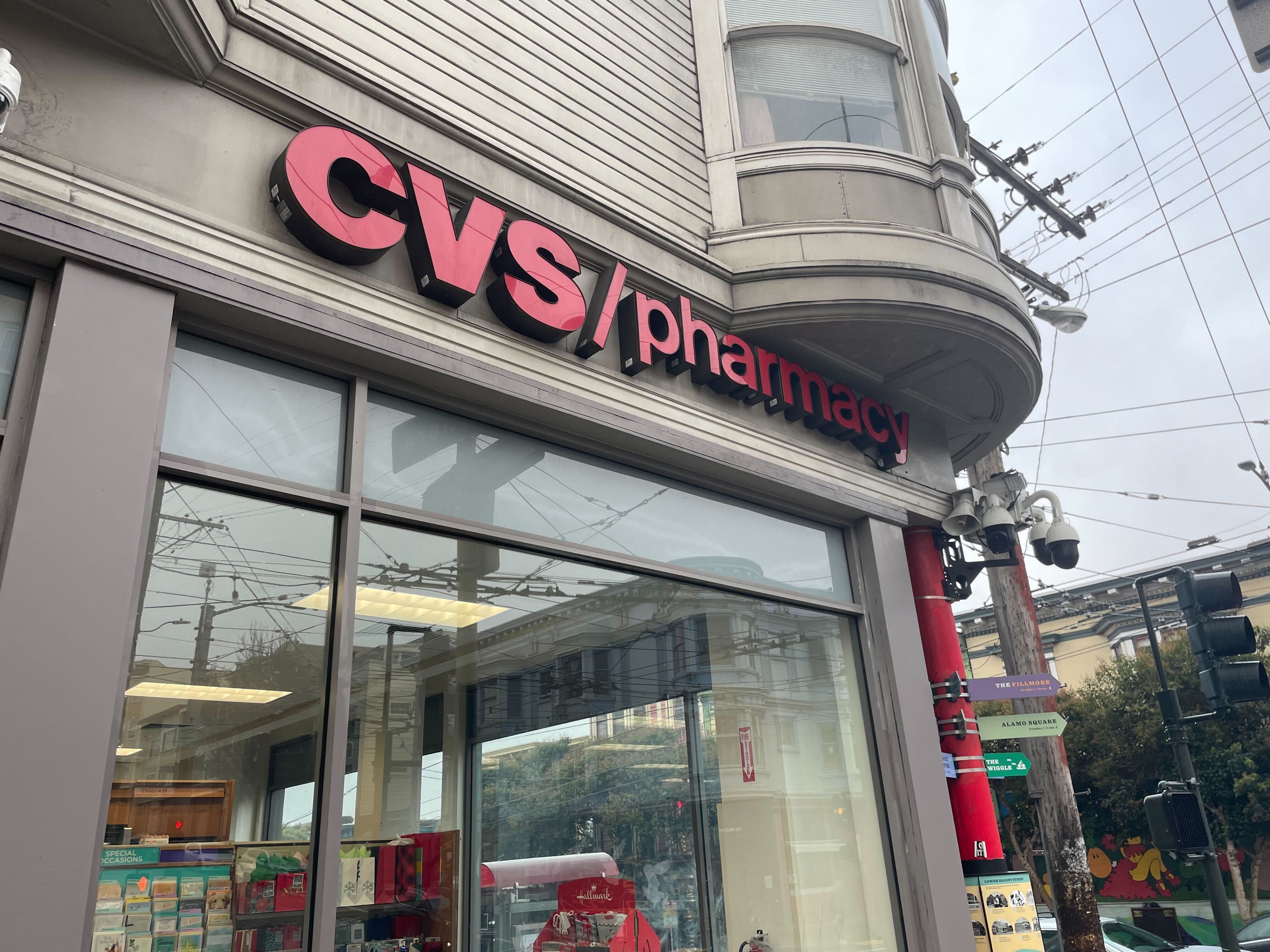 A red CVS/pharmacy sign affixed to a corner building