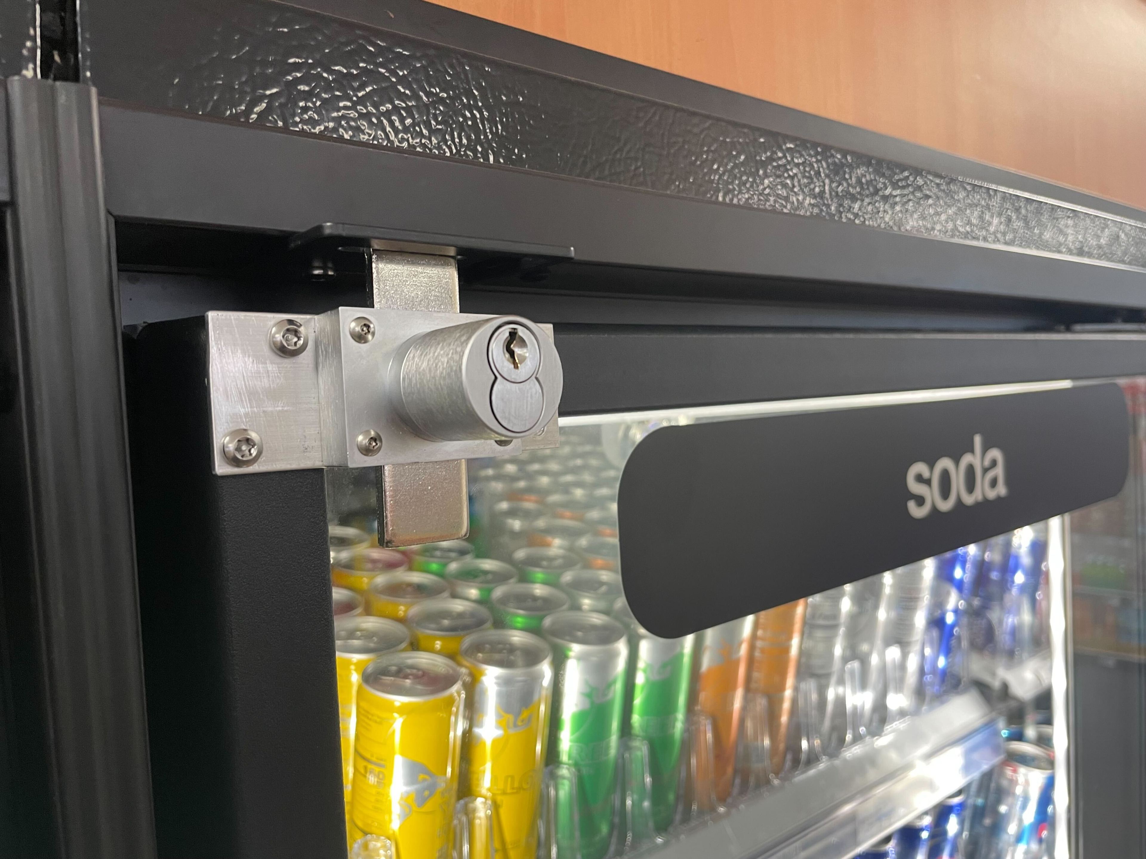 A locked refrigerator with soda inside