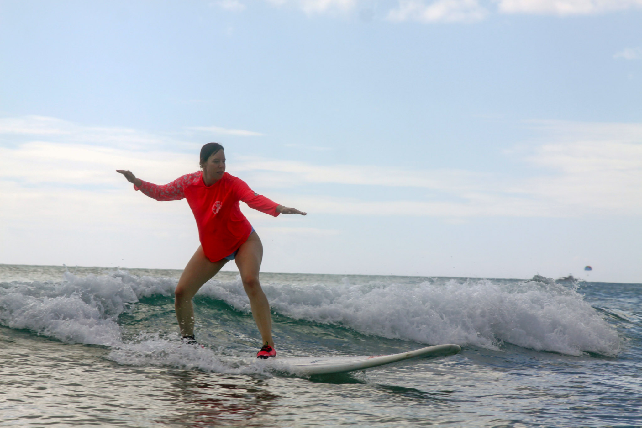 A woman rides a surfboard. 