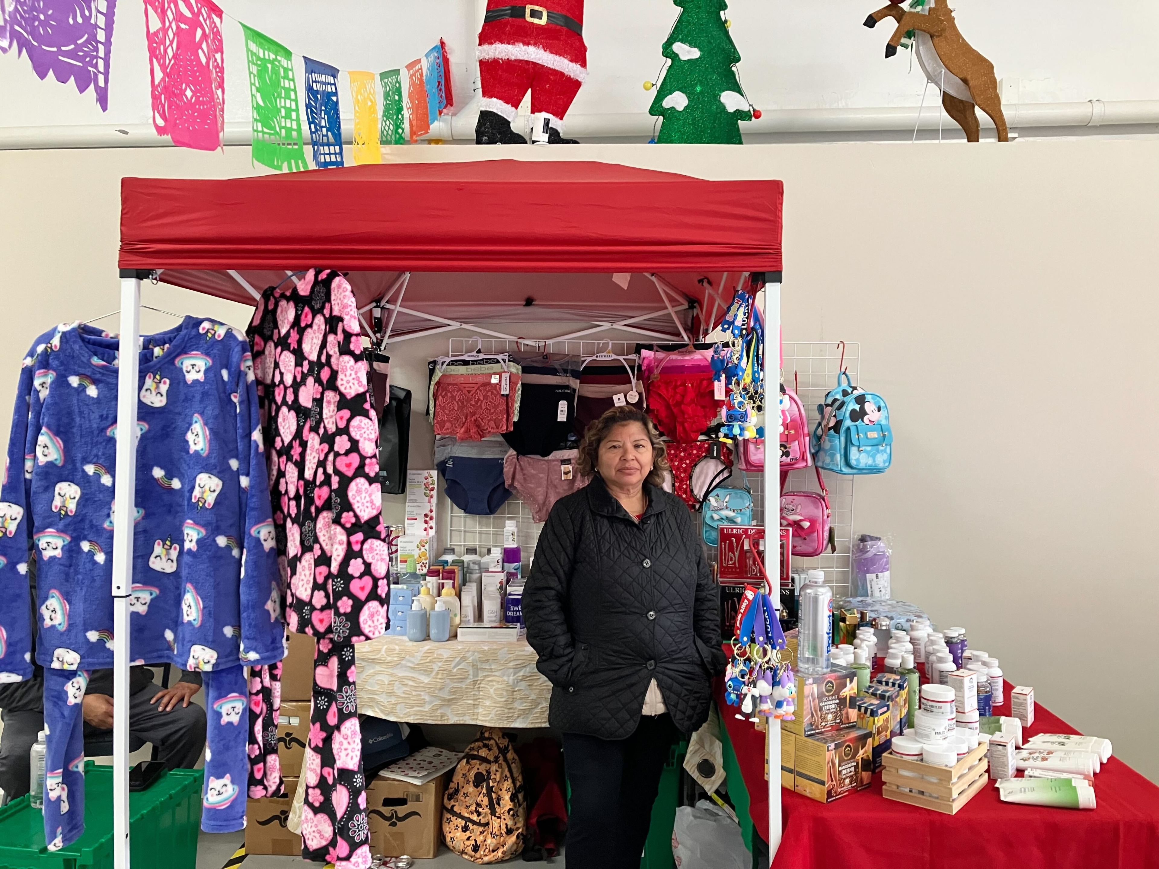 Maria Avila stands next to her items inside the vendor space at 2137 Mission Street. Avila says she has only made $20-30 in the six days of being at the location.