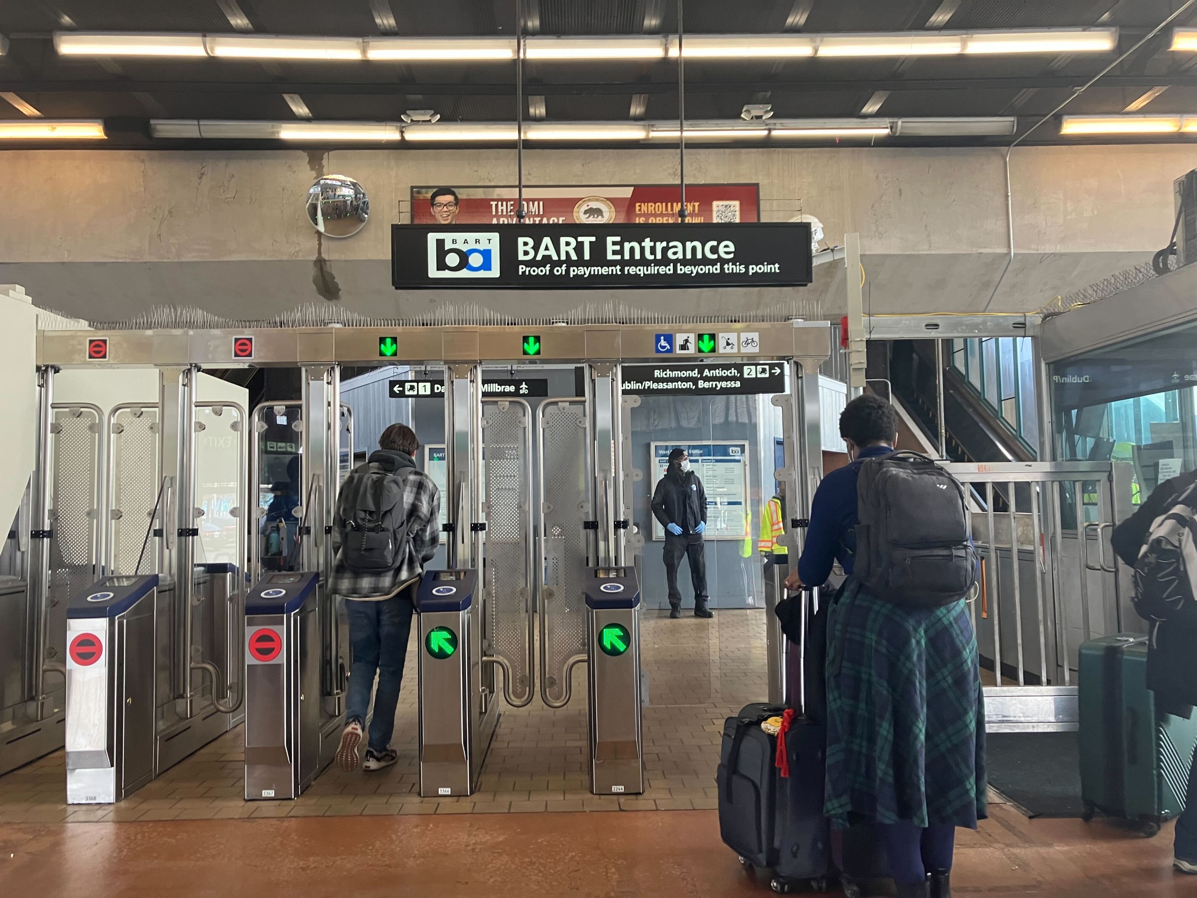 BART riders pass through the newly opened fare gates at West Oakland Station on Dec. 28, 2023.