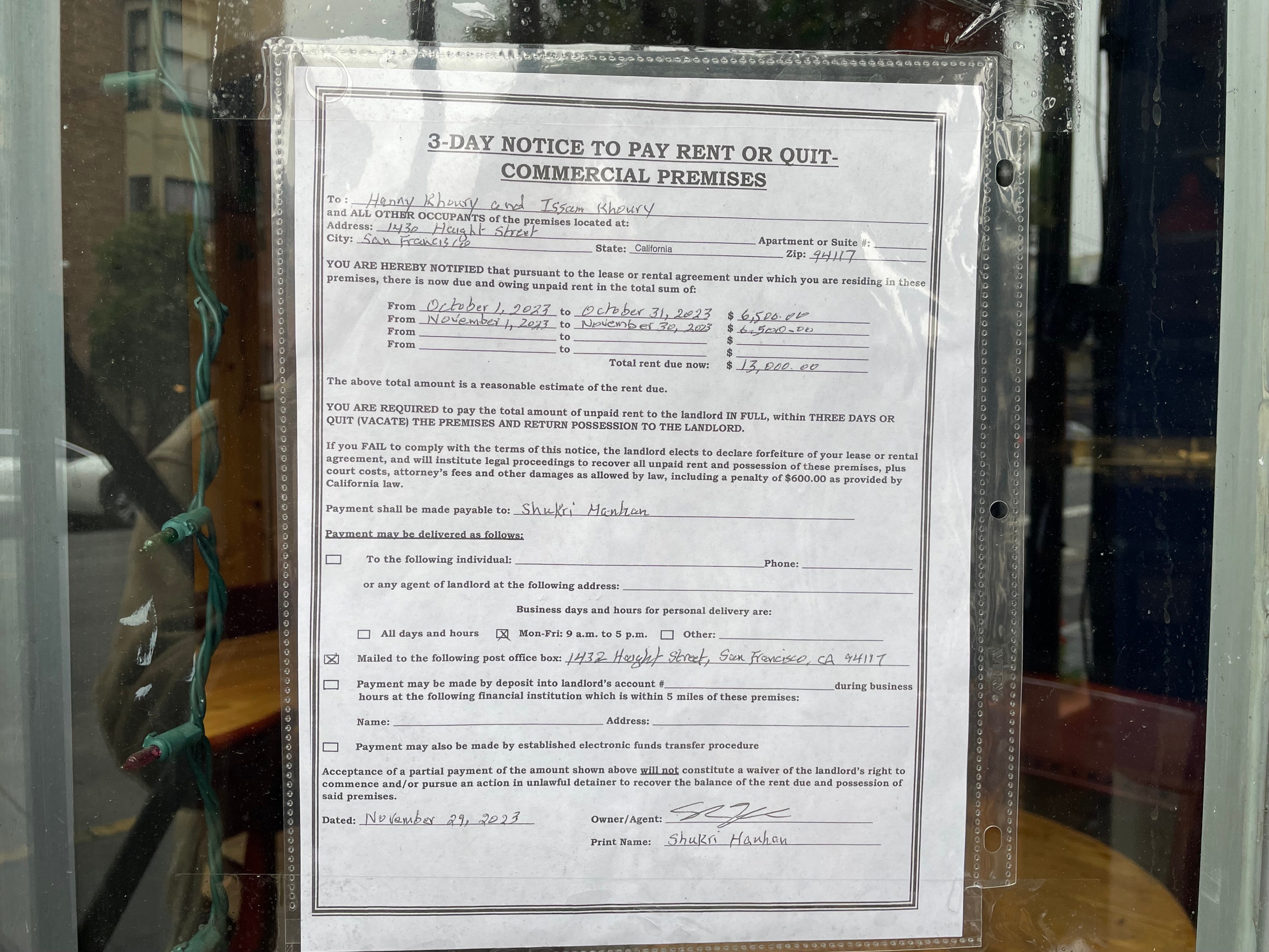 An eviction notice is posted in a restaurant window.