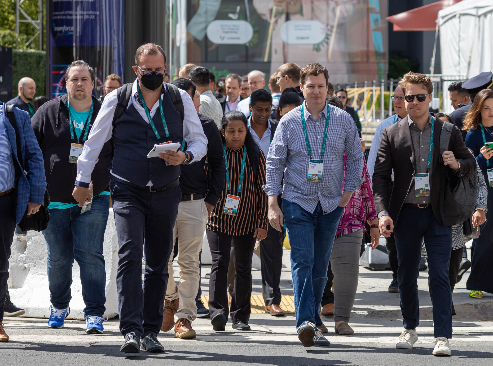 A crowd of Dreamforce attendees cross the street in San Francisco.