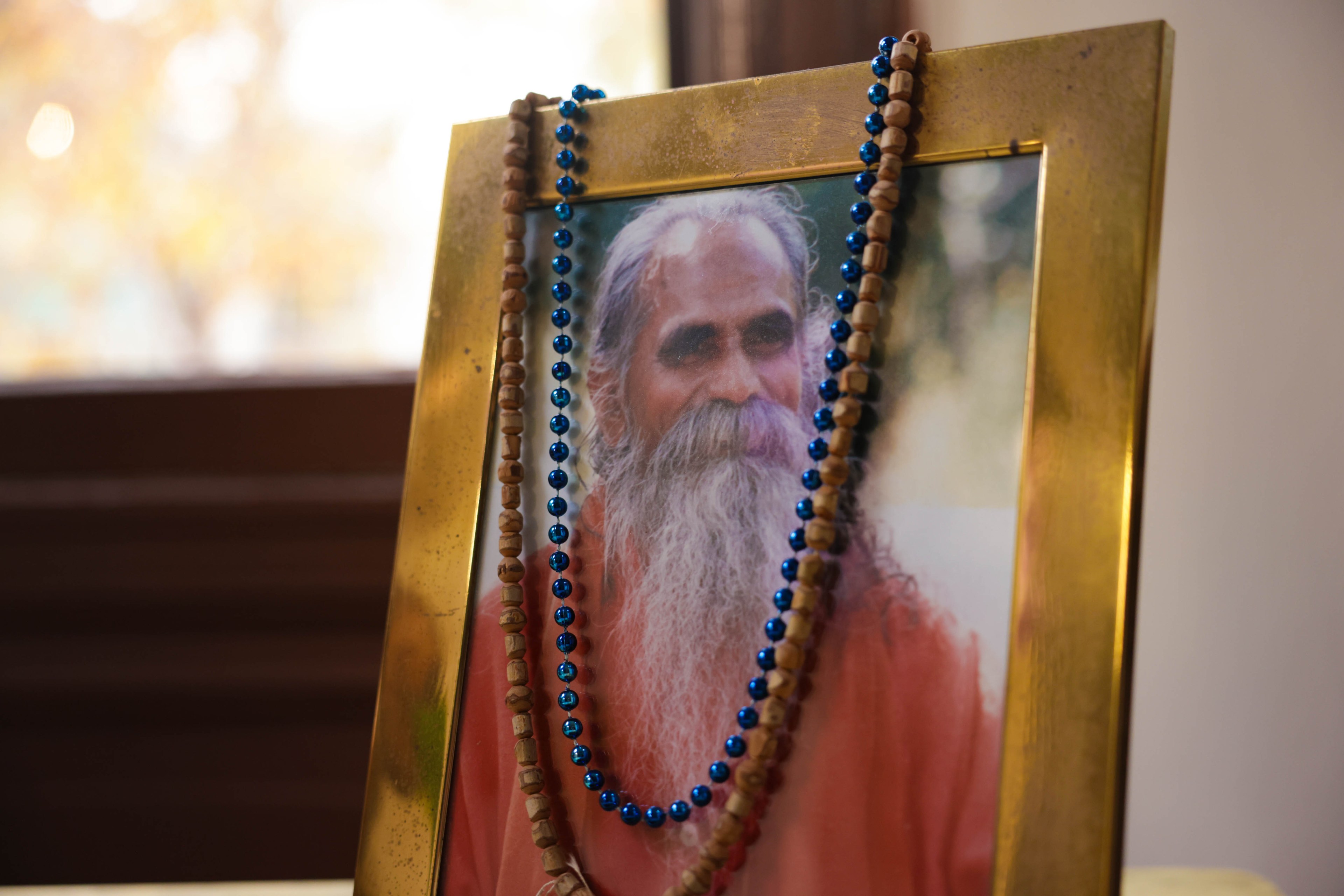 A detail of photo of Shri Brahmananda Sarasvati with beads hanging off the top