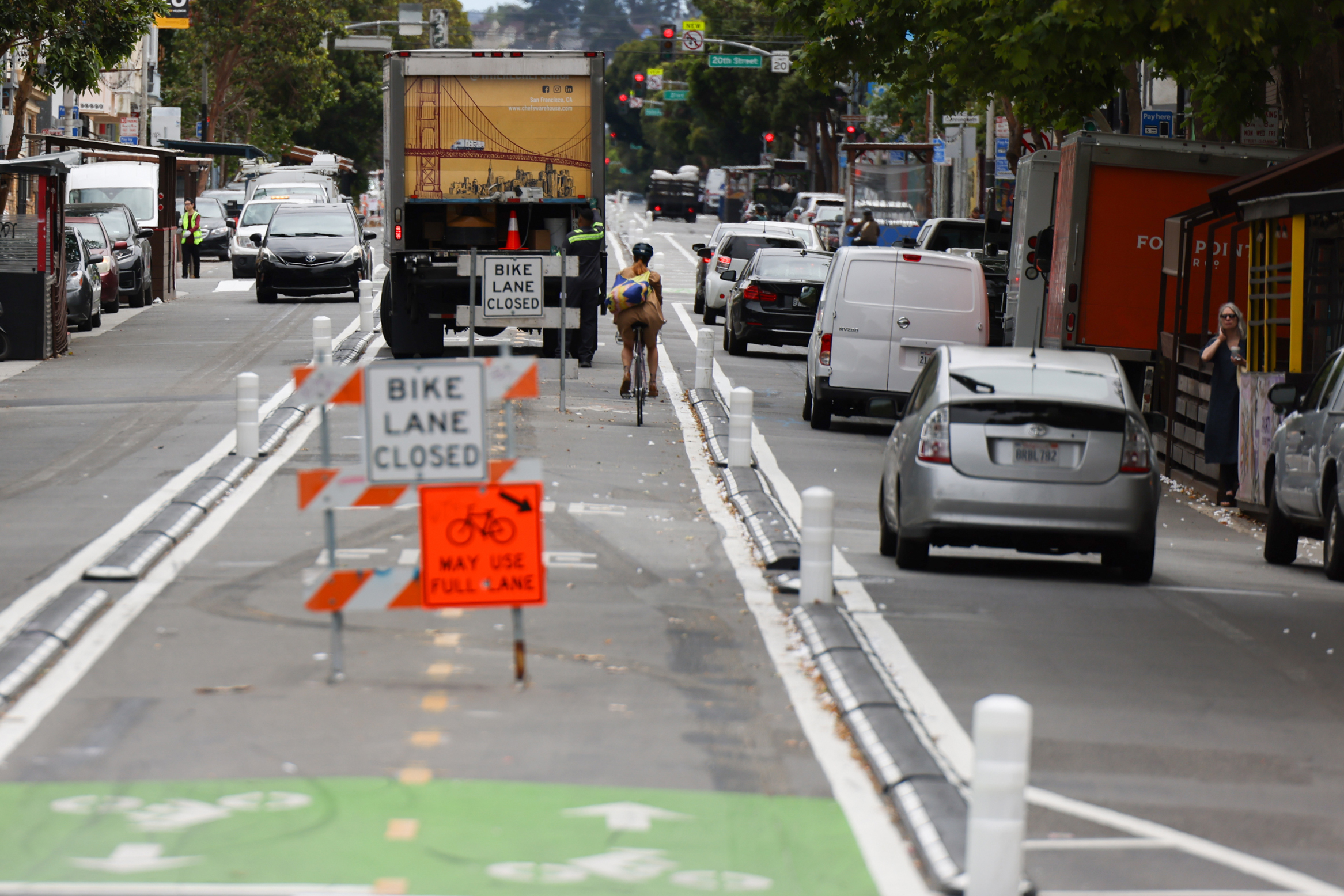 A caution sign warns cyclists in a yet-to-be-completed bike lane.