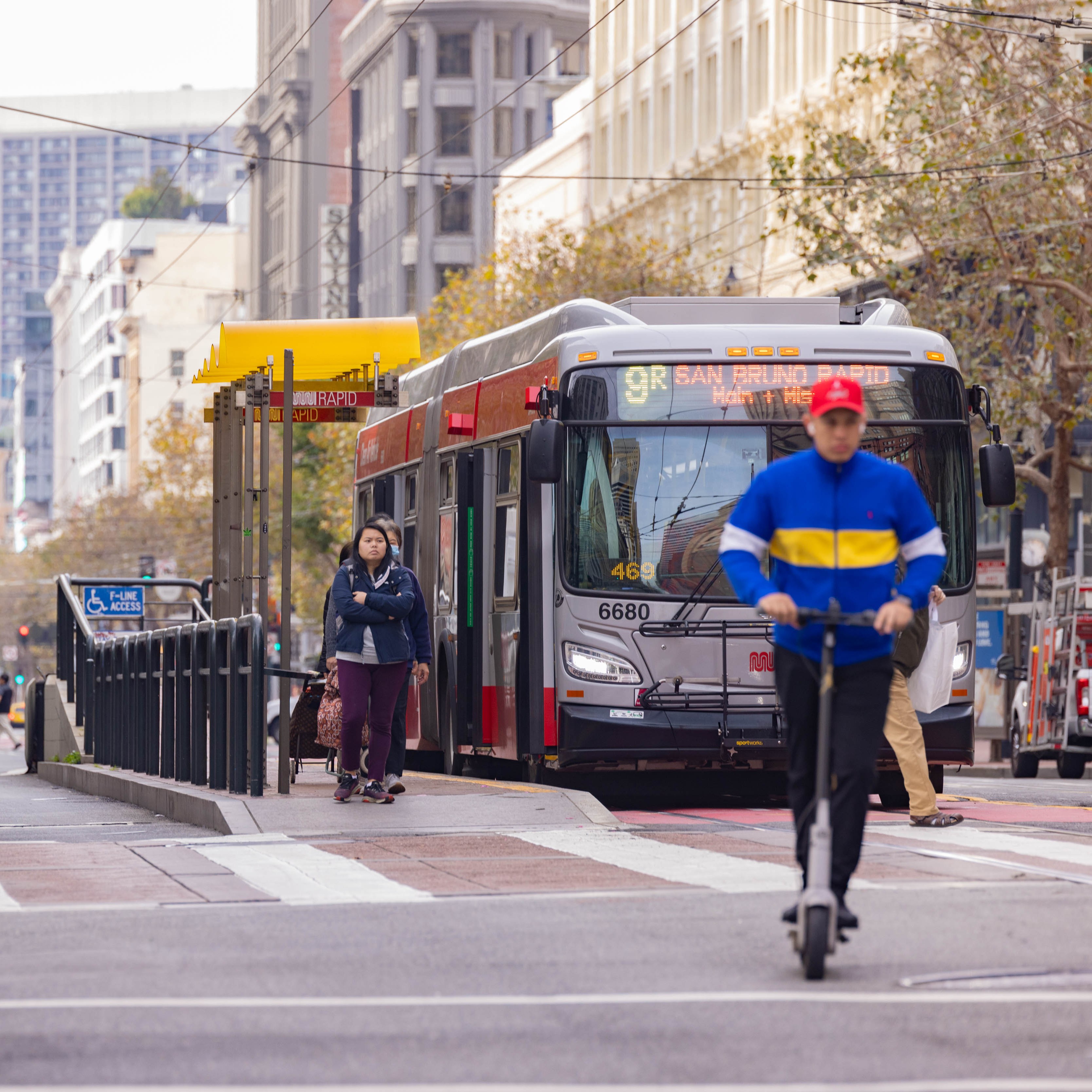 Bicyclists and scooter riders make their way down Market St.