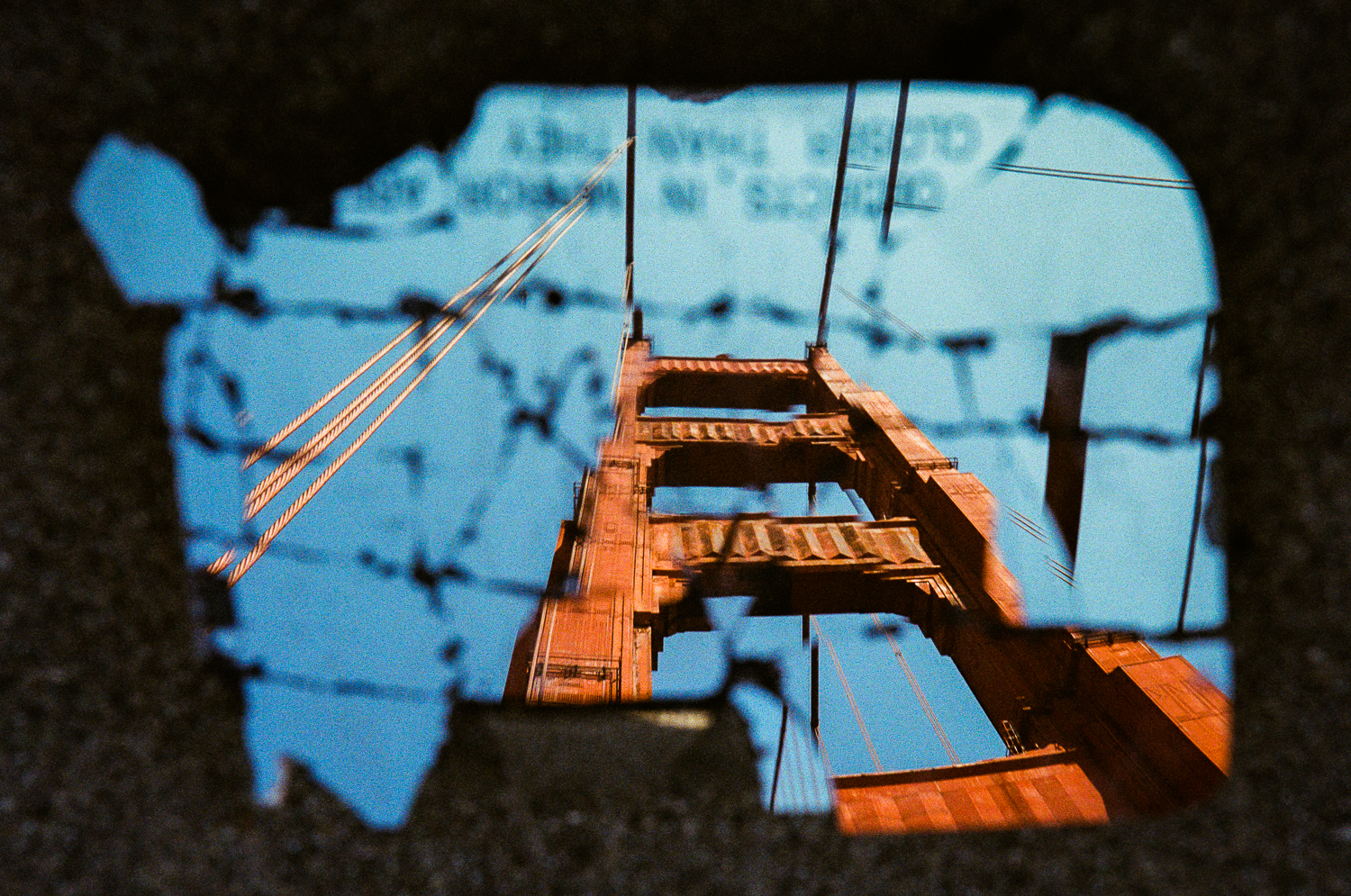 A reflection from the broken remains of a car's side mirror shows the Golden Gate Bridge's south tower in October 2020.