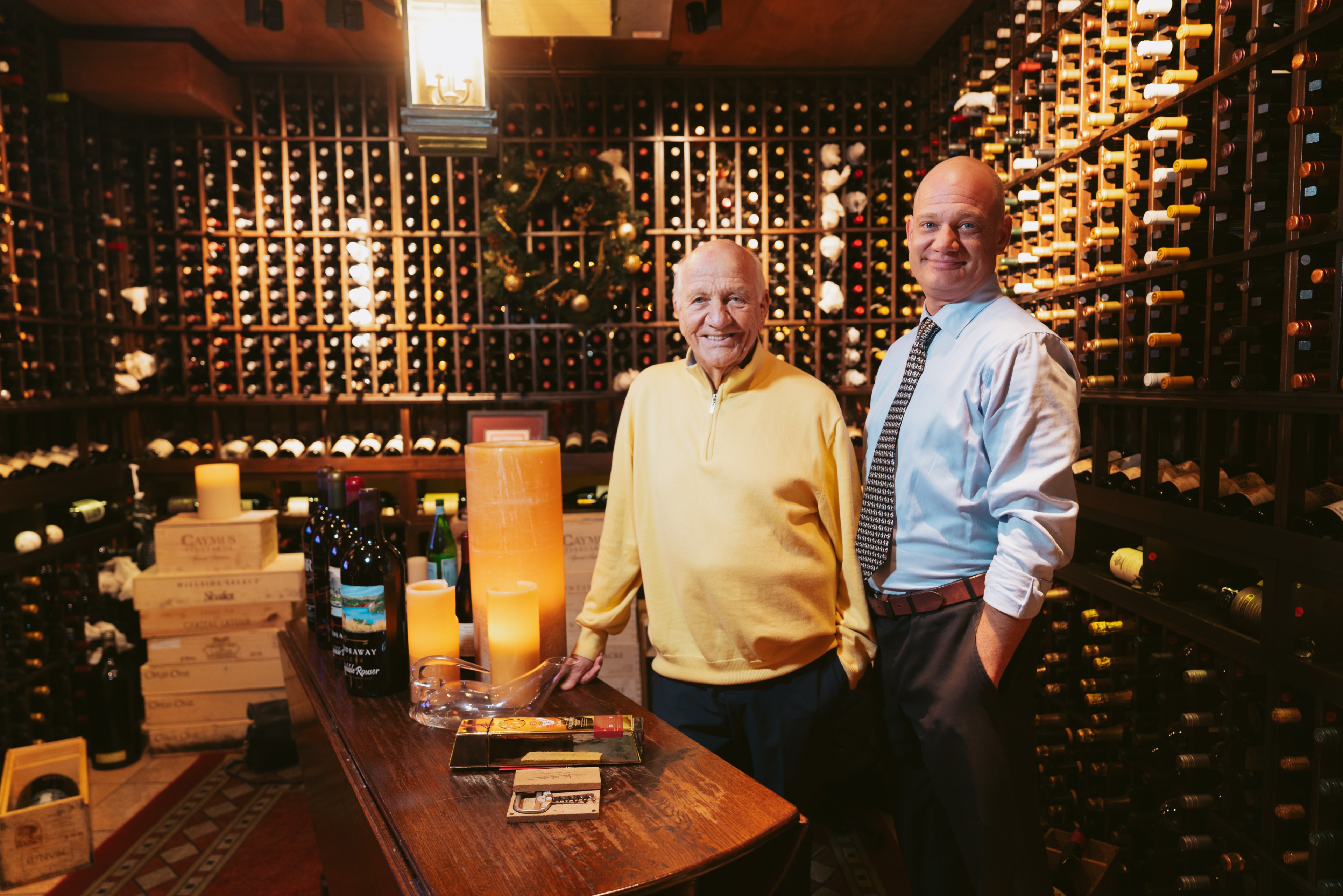 Two people standing in a wine room of the House of Prime Rib. 