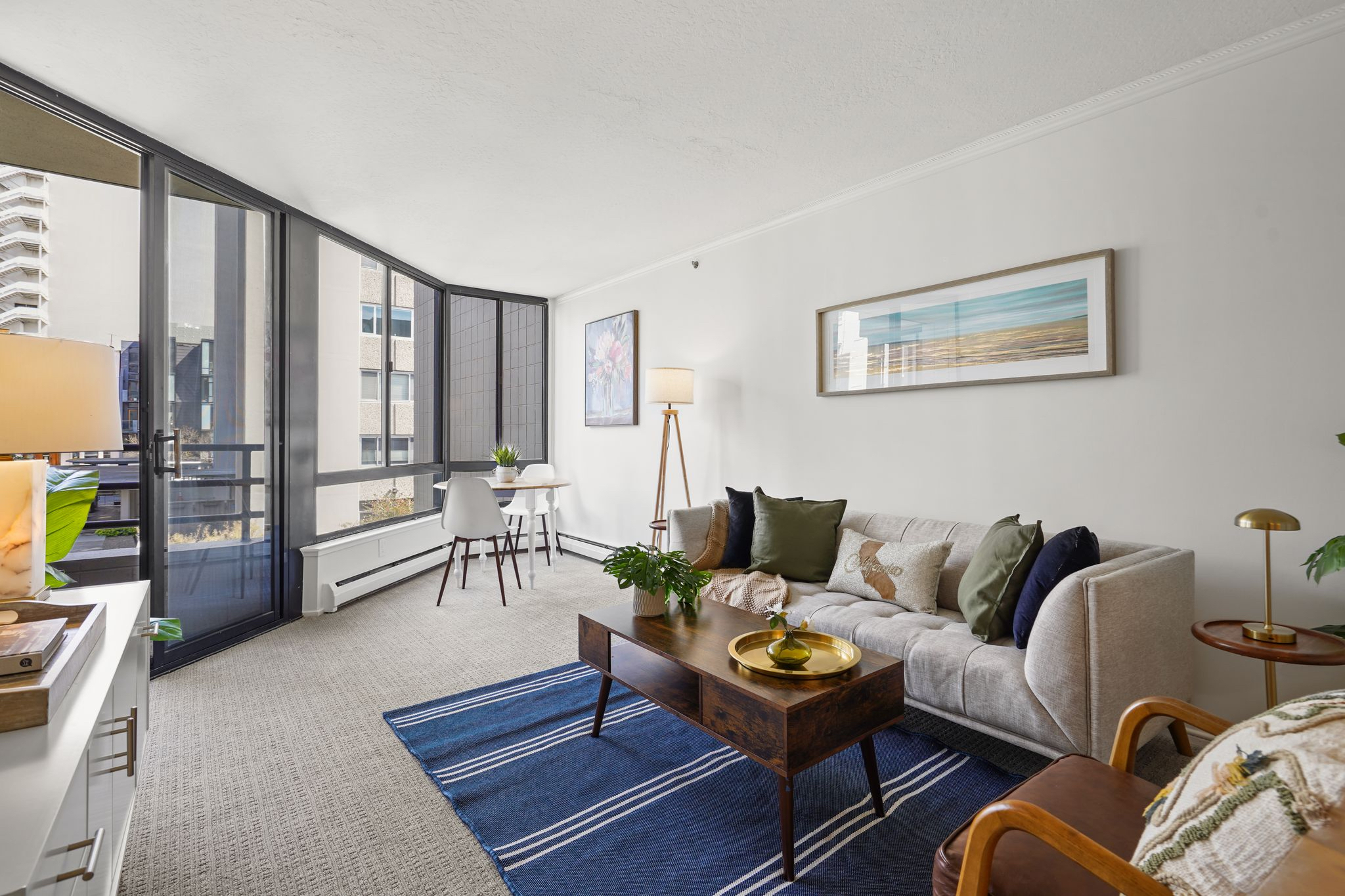 A staged living room for a condo listing shows a couch and coffee table.