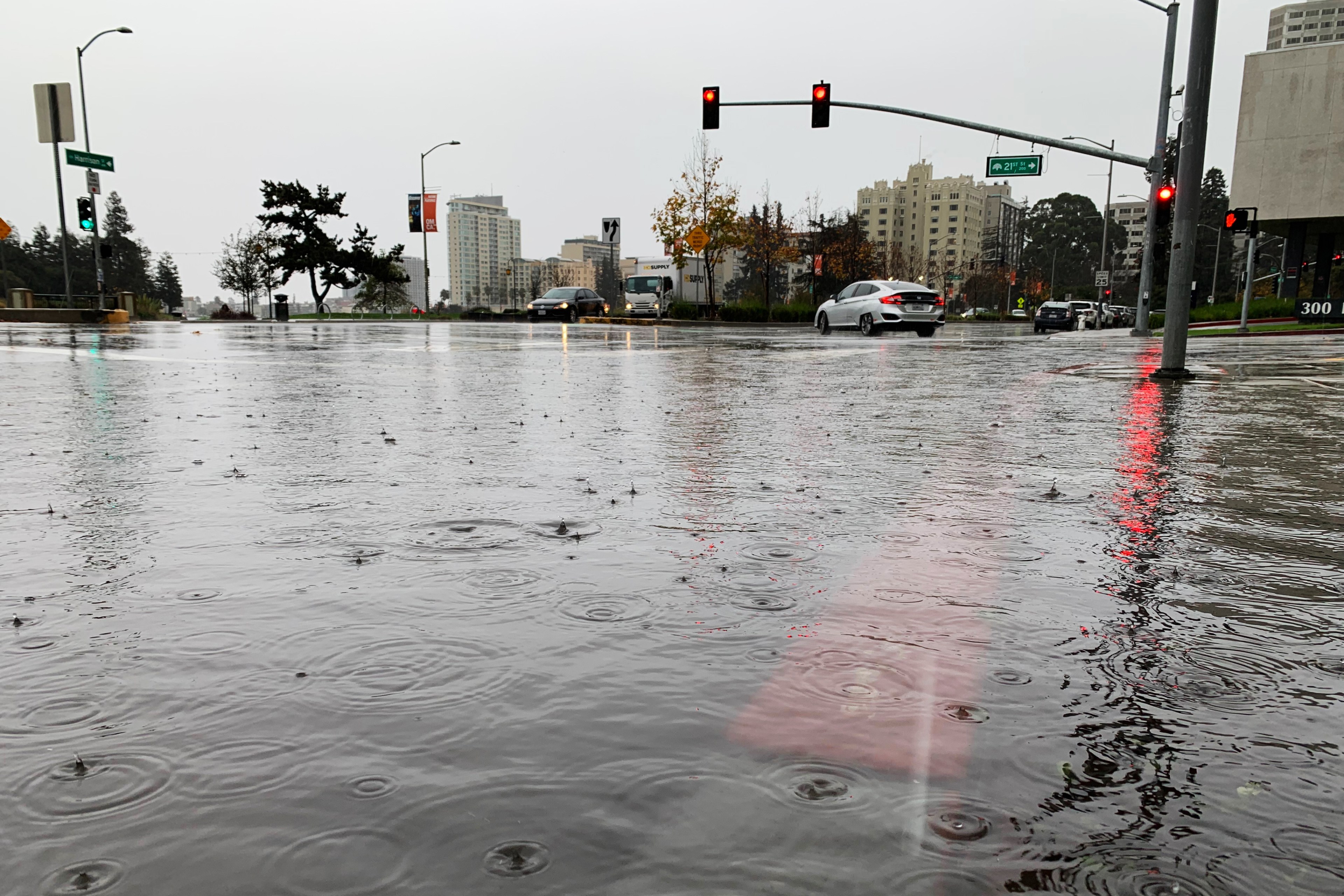 Rainwater gathers to create moderate flooding at the intersection.