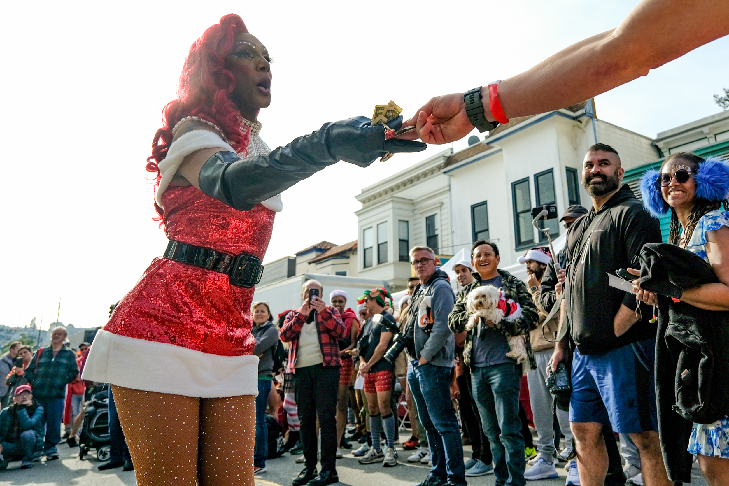 A person dressed in a Santa's outfit talks with people before an underwear fun run