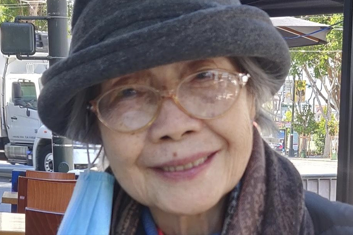 A tight portrait of an older woman smiling.