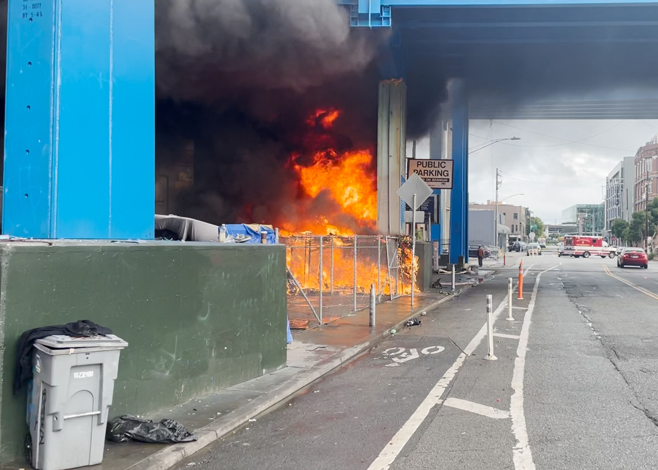 A fire rages underneath the Central Freeway on December 19, 2023.