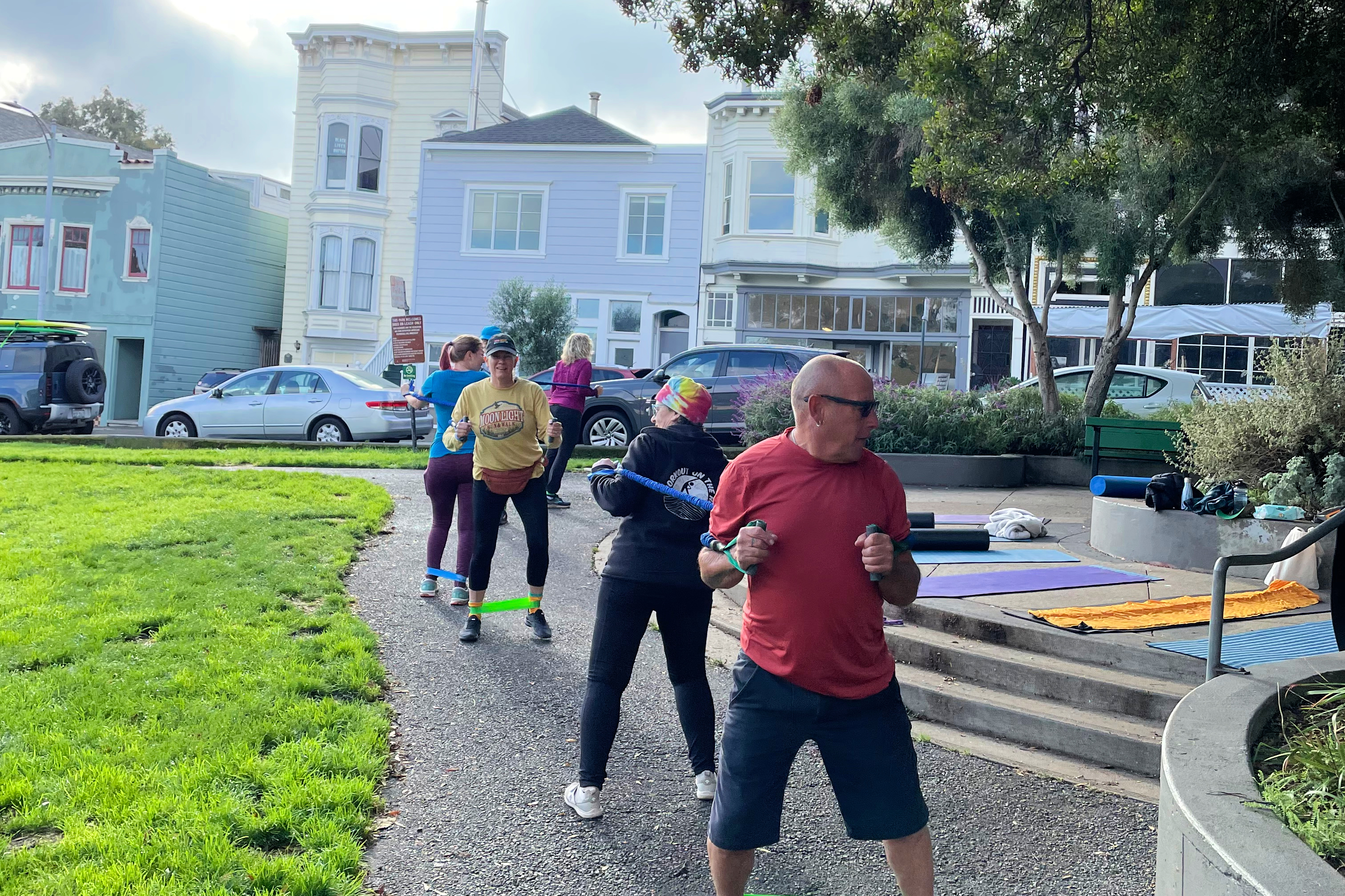 A line of people exercising in a San Francisco park. 