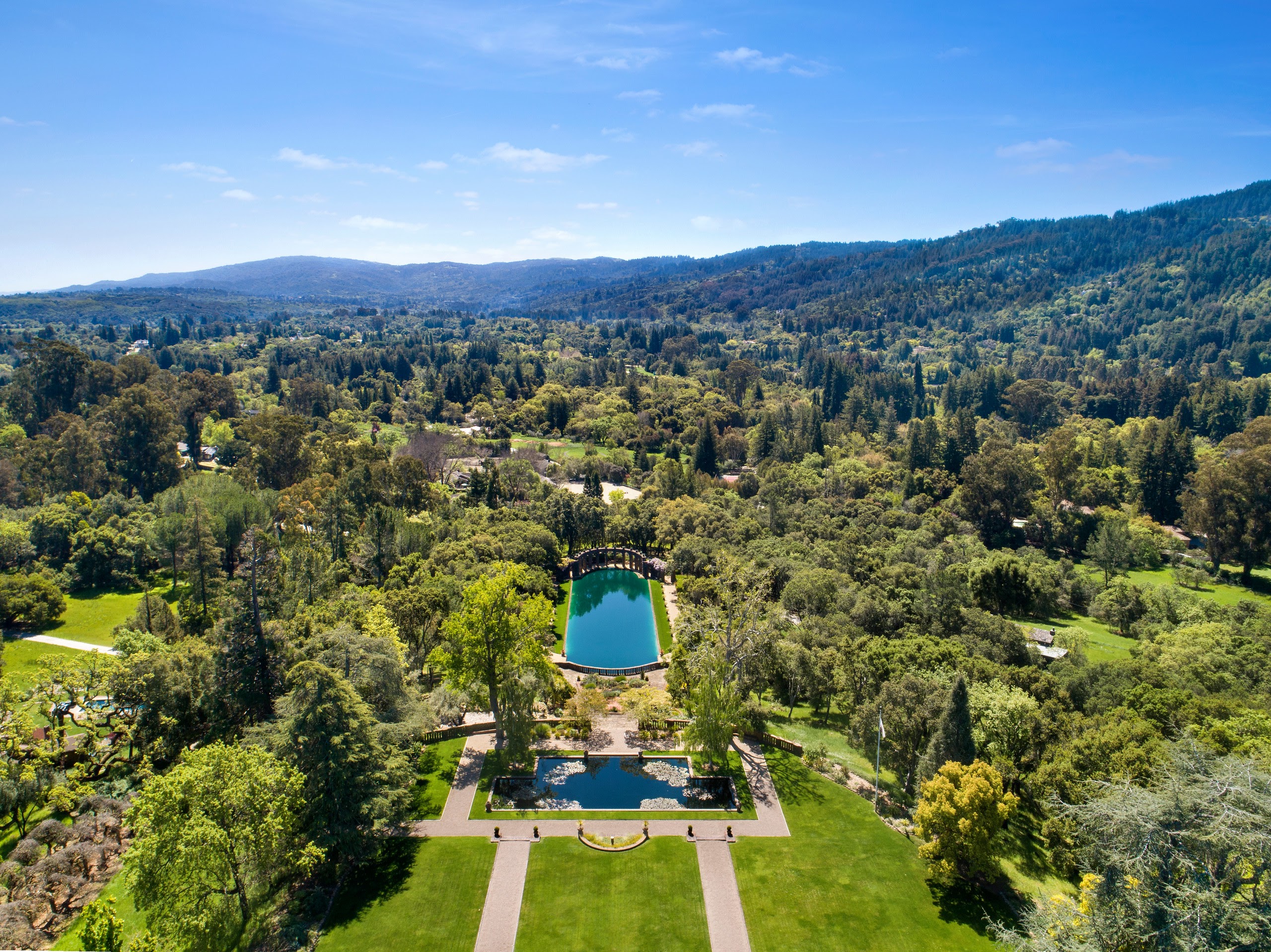 An aerial view of a mansion surrounded by trees. 