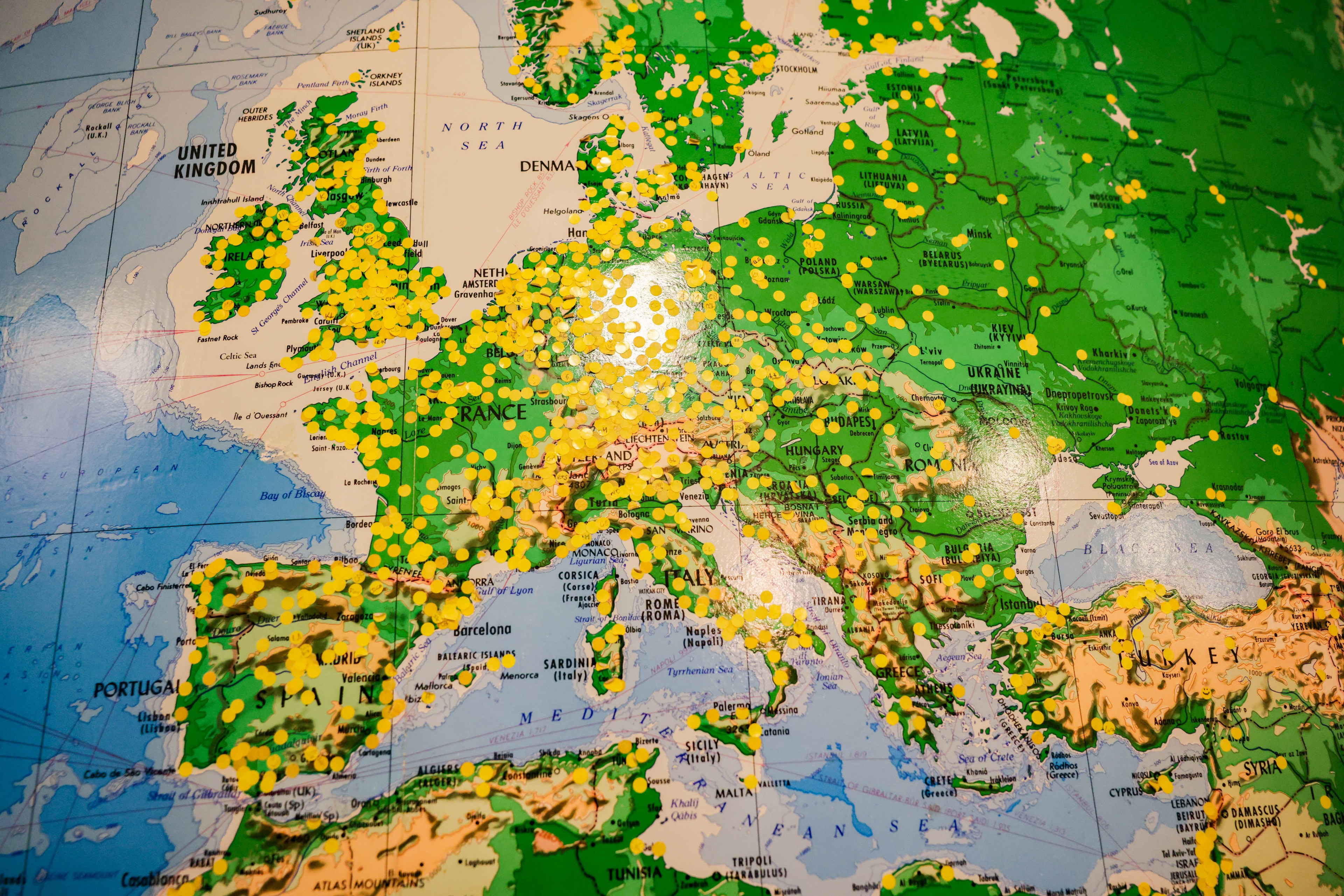 A map of Europe with numerous yellow and green pins marking locations across various countries.