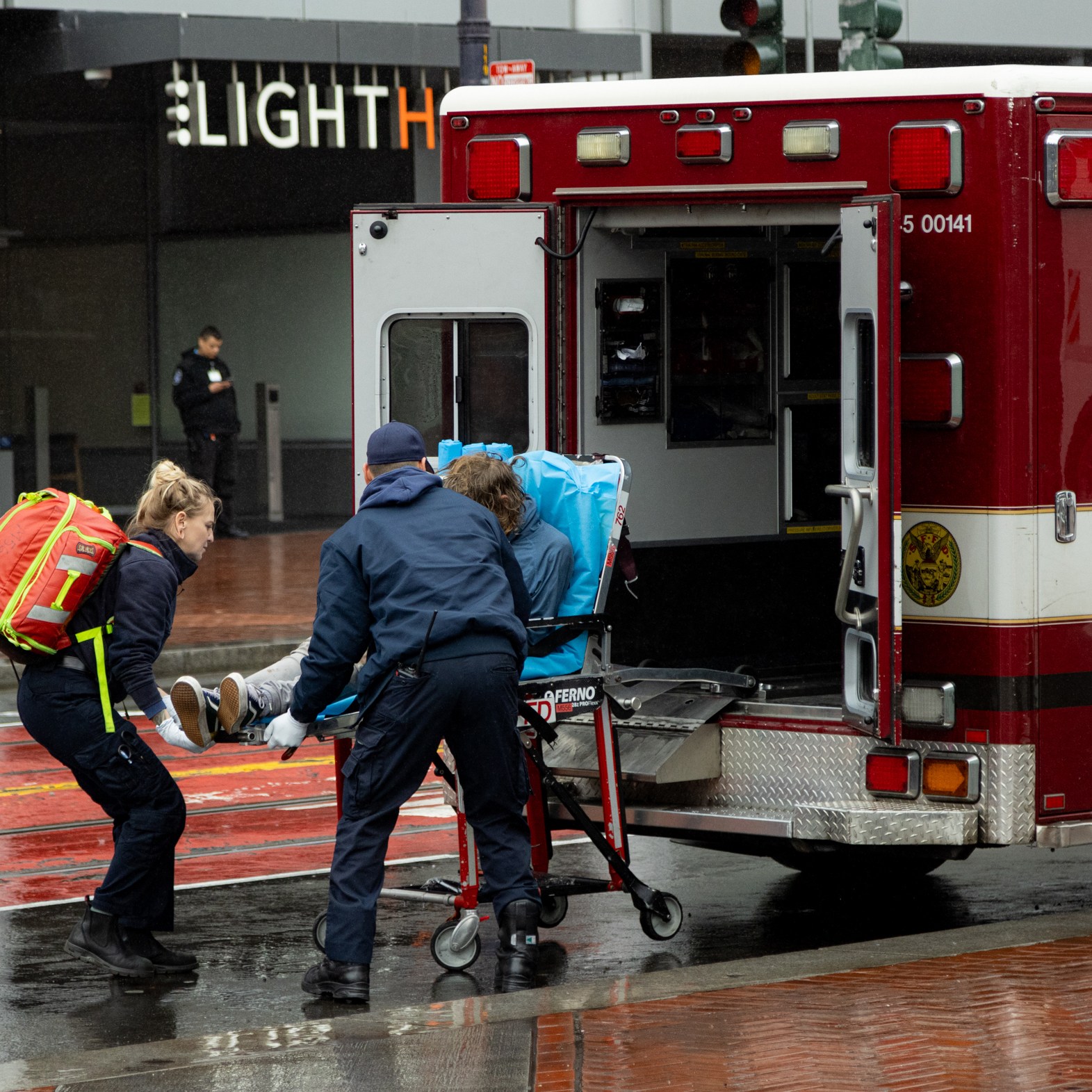 Paramedics load a person on a stretcher into an ambulance labeled "San Francisco Fire Department."