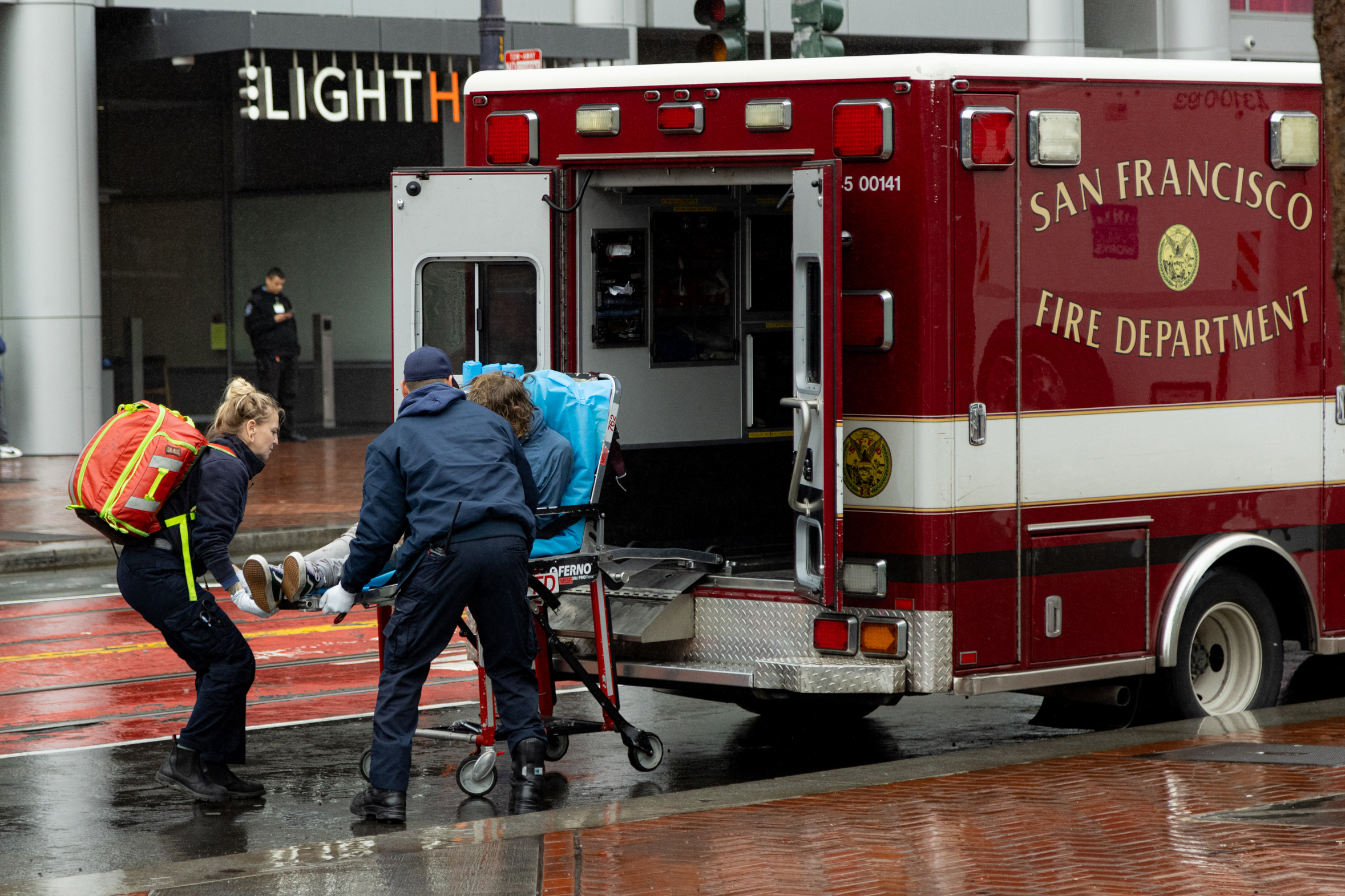 Paramedics load a person on a stretcher into an ambulance labeled &quot;San Francisco Fire Department.&quot;