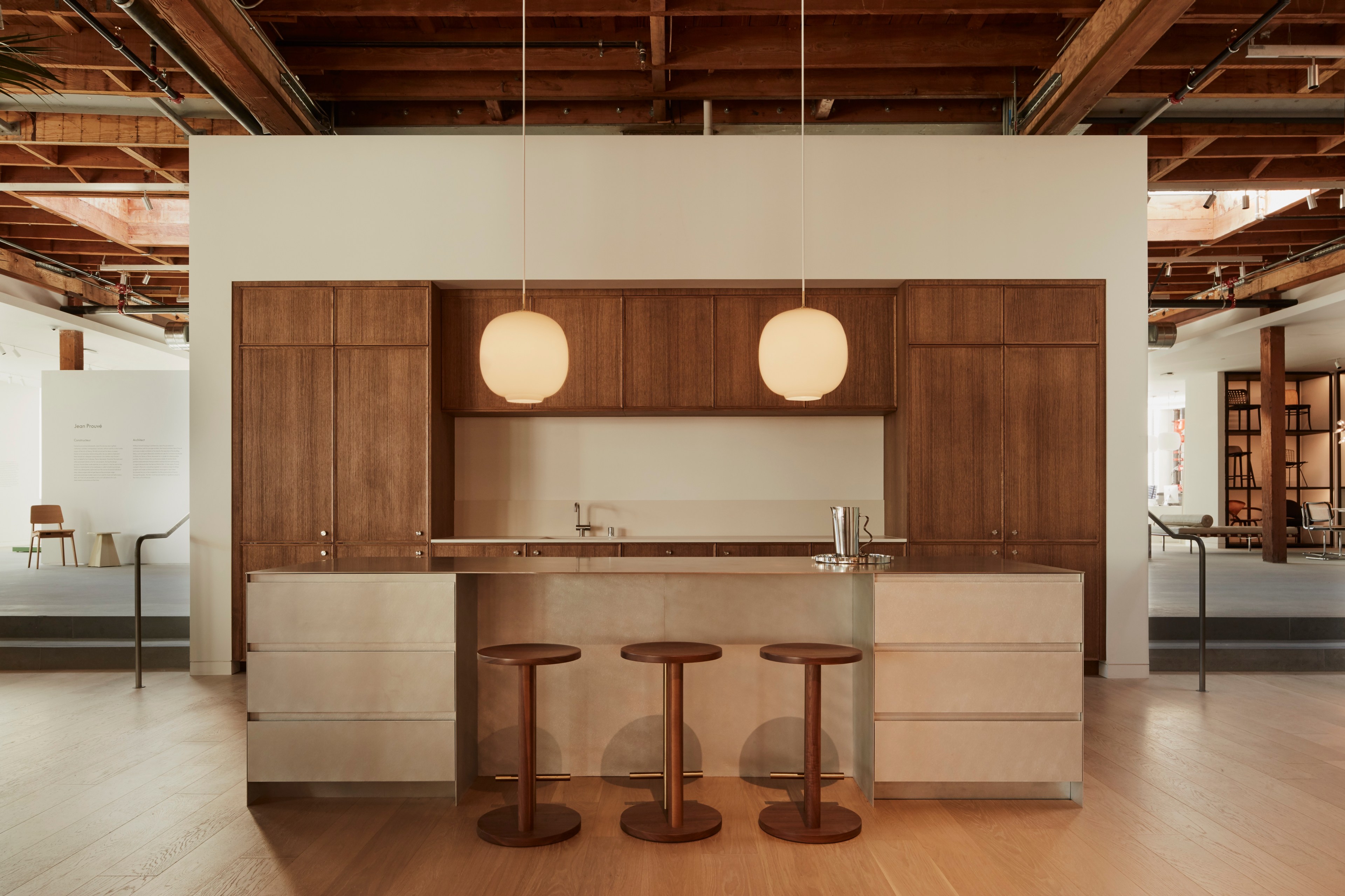 Wooden cabinetry lines the back of a sample kitchen in a Design Within Reach furniture store in San Francisco.