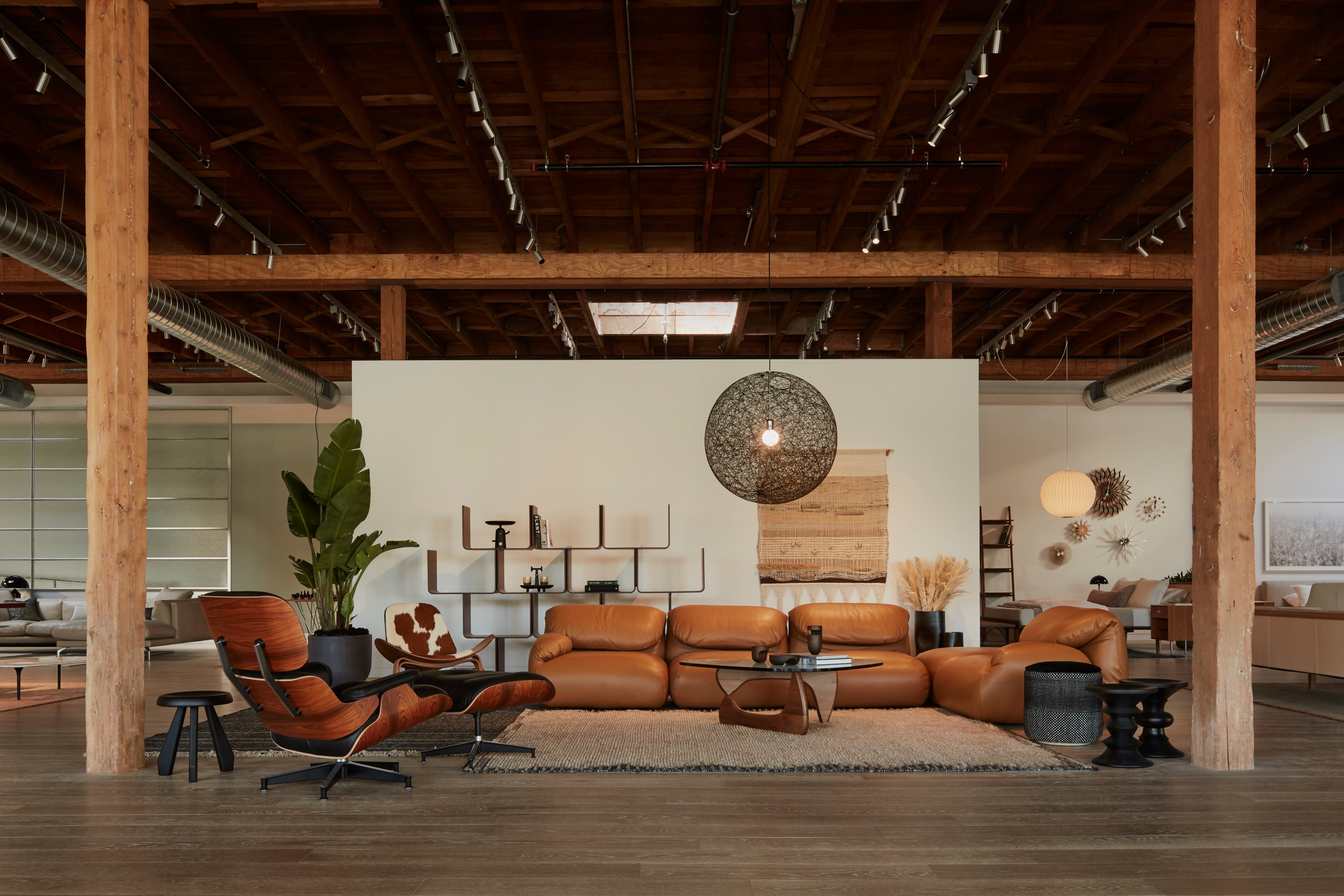 Design Within Reach's new San Francisco showroom features brown leather couches and Eames chairs.