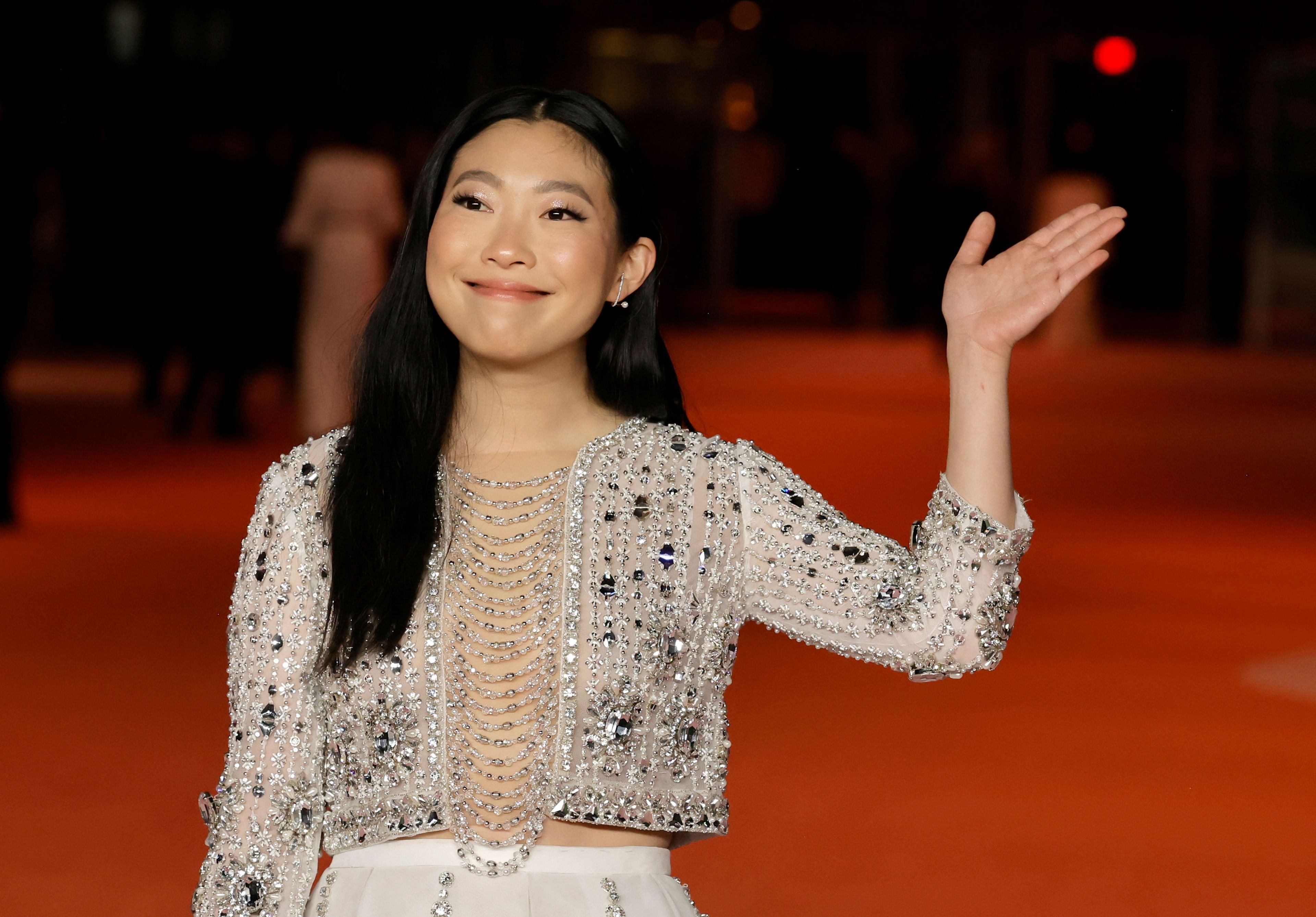Woman waving hand on red carpet event