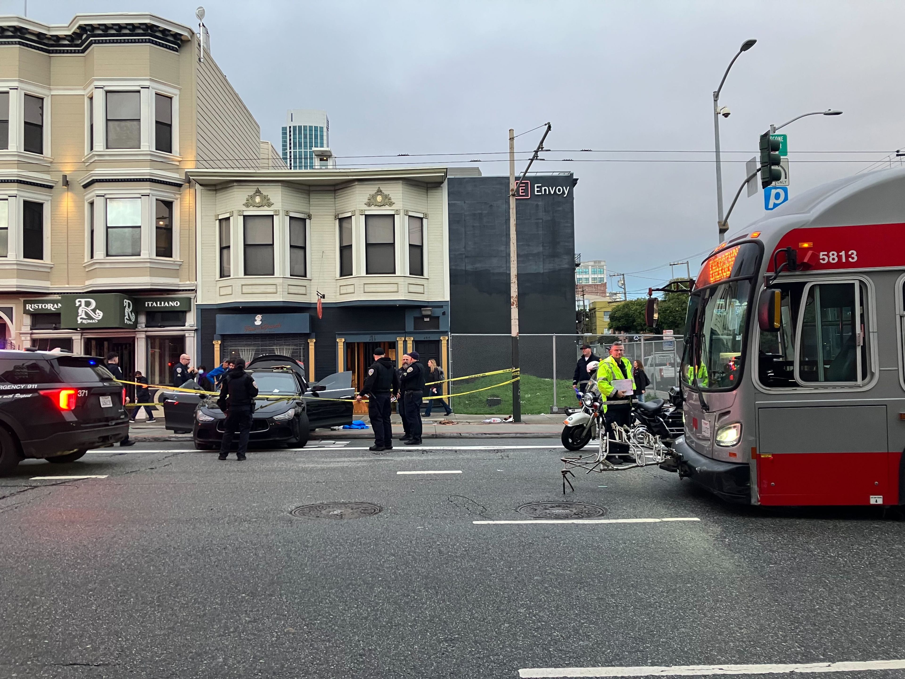 San Francisco Police Department investigators search a Maserati that collided with a Muni bus during a pursuit that ended near 3rd and Bryant streets on Wednesday, Jan. 24, 2024.