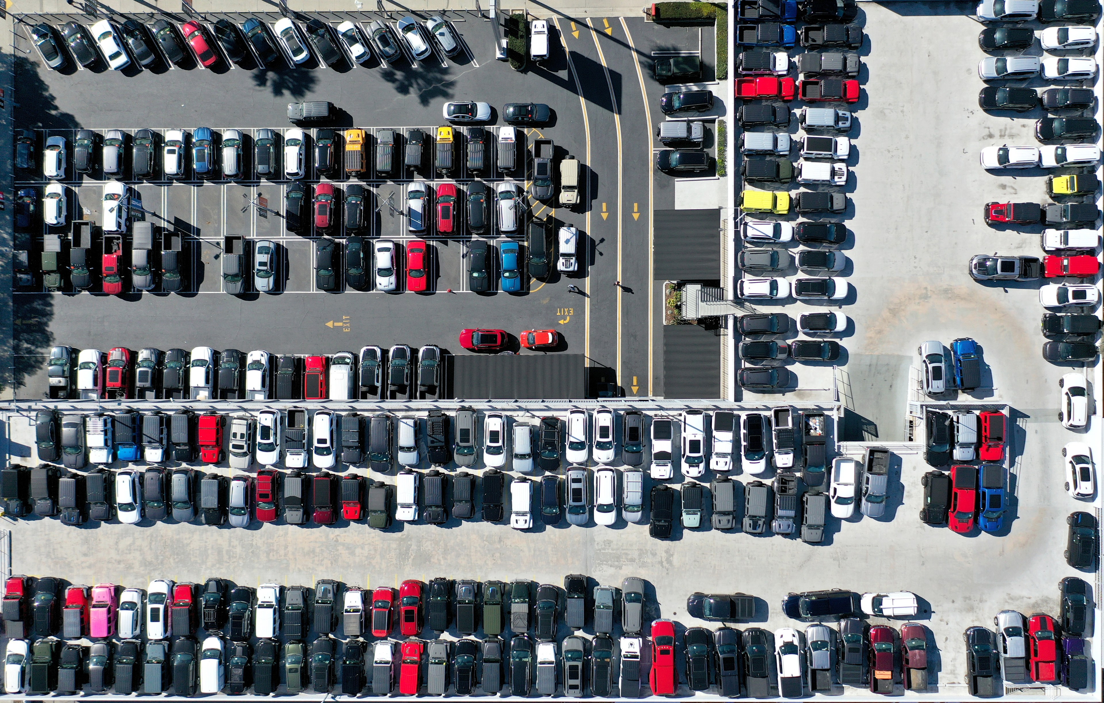 An aerial view of cars in a parking lot.