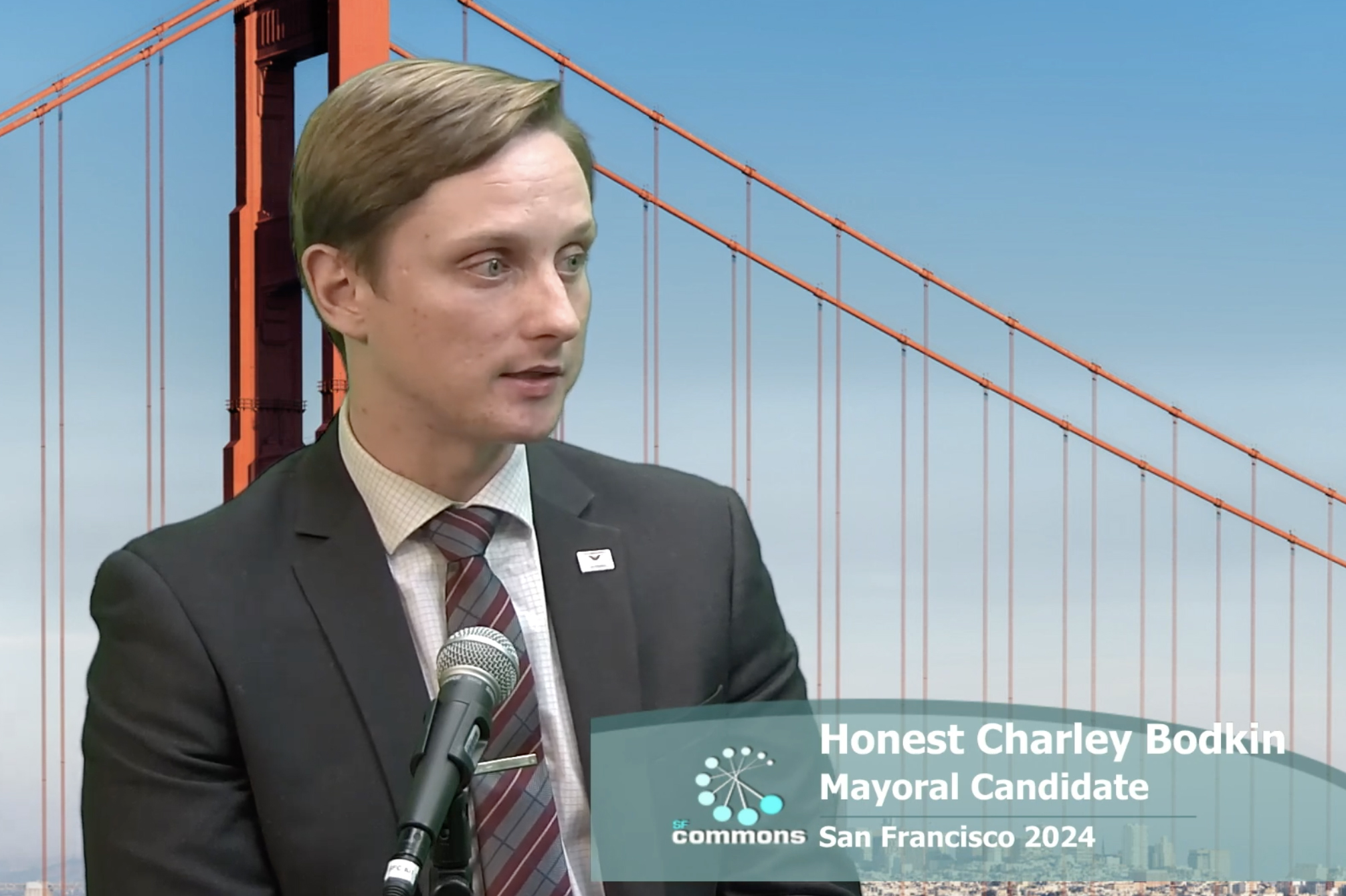 A man stands before a mic; &quot;Honest Charley Bodkin, Mayoral Candidate&quot; is captioned against a Golden Gate Bridge backdrop.