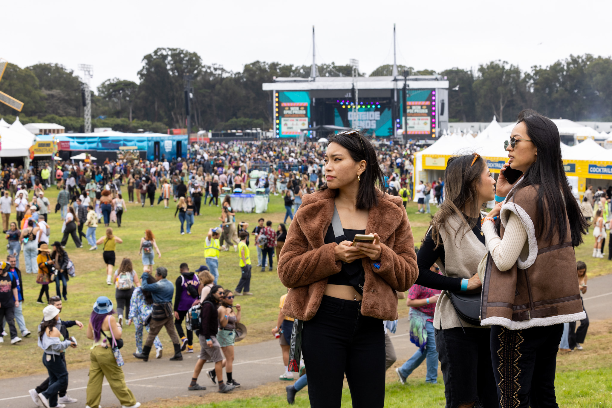 A woman holds her cellphone at the Outside Lands Music Festival in Golden Gate Park.