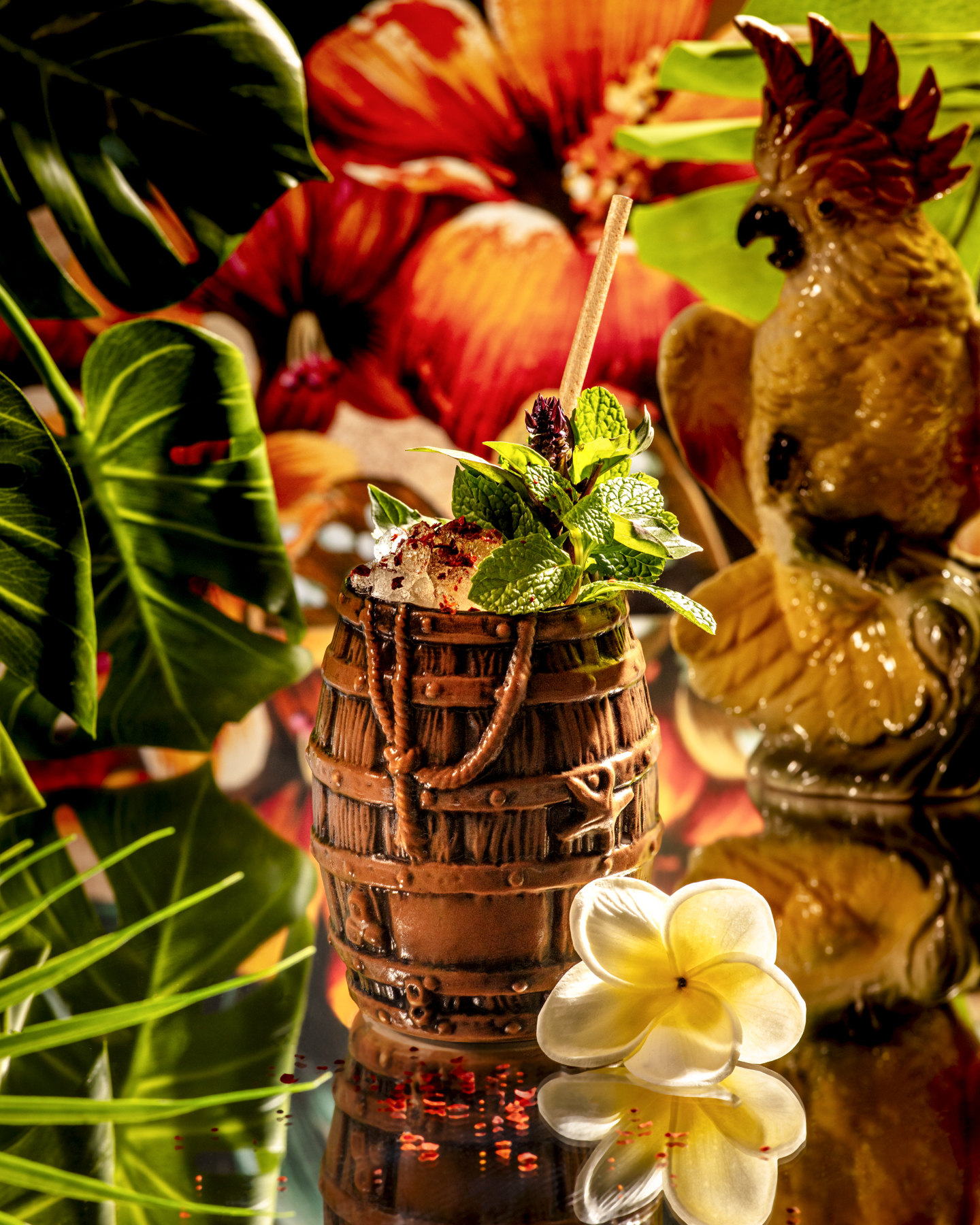 a flowery, maximalist shot of a tiki cocktail