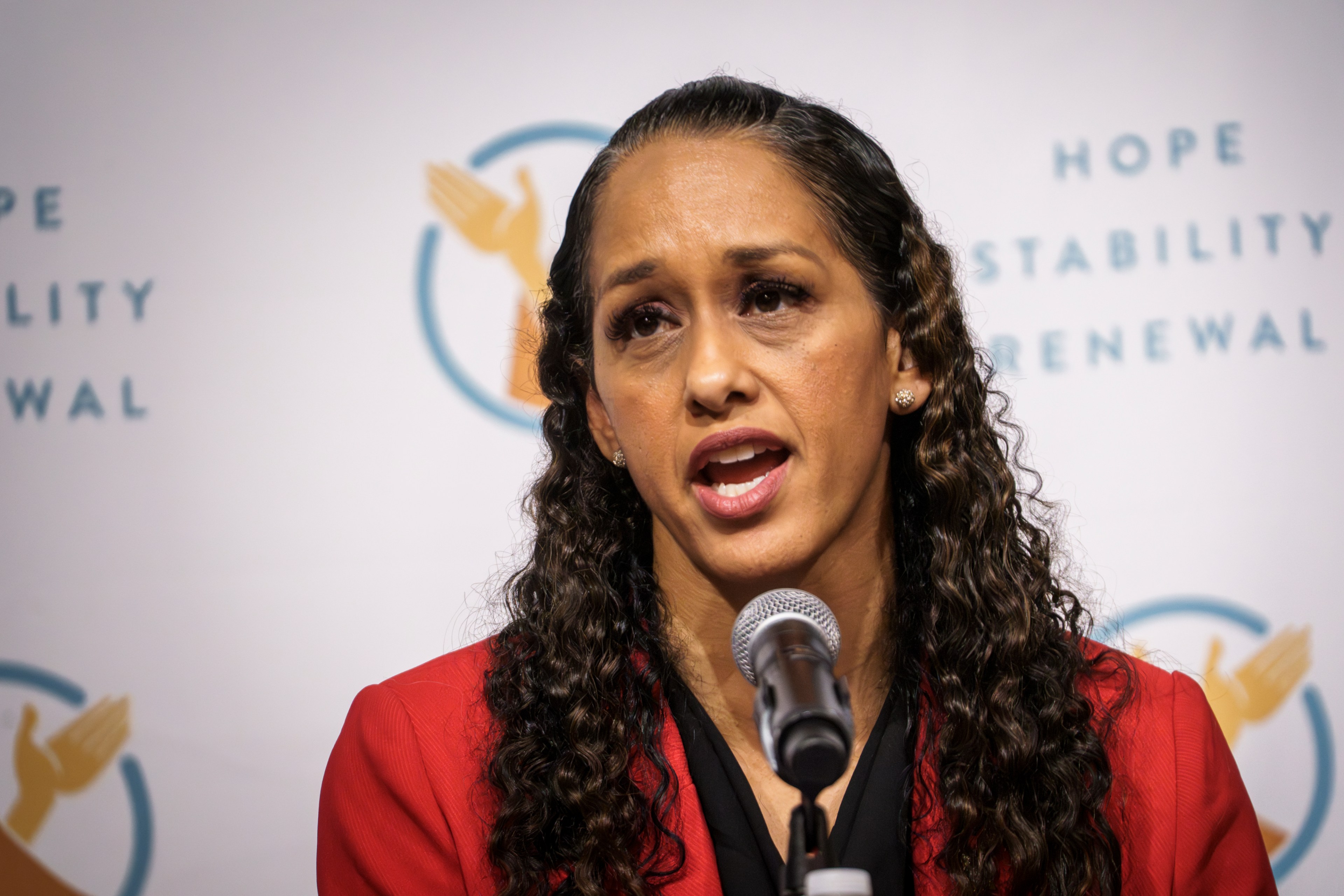 San Francisco District Attorney Brooke Jenkins speaks into a microphone.