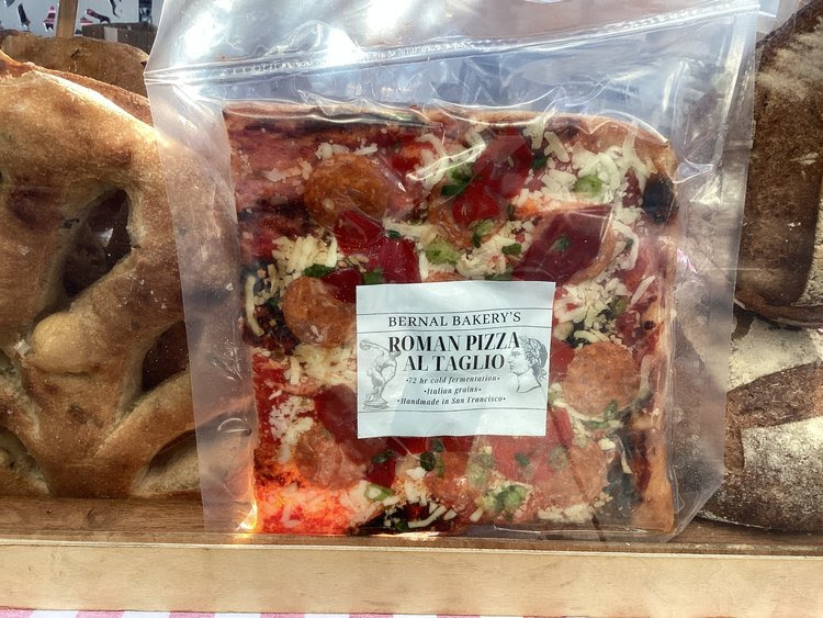 A pizza is in a shrink-wrapped plastic package. 