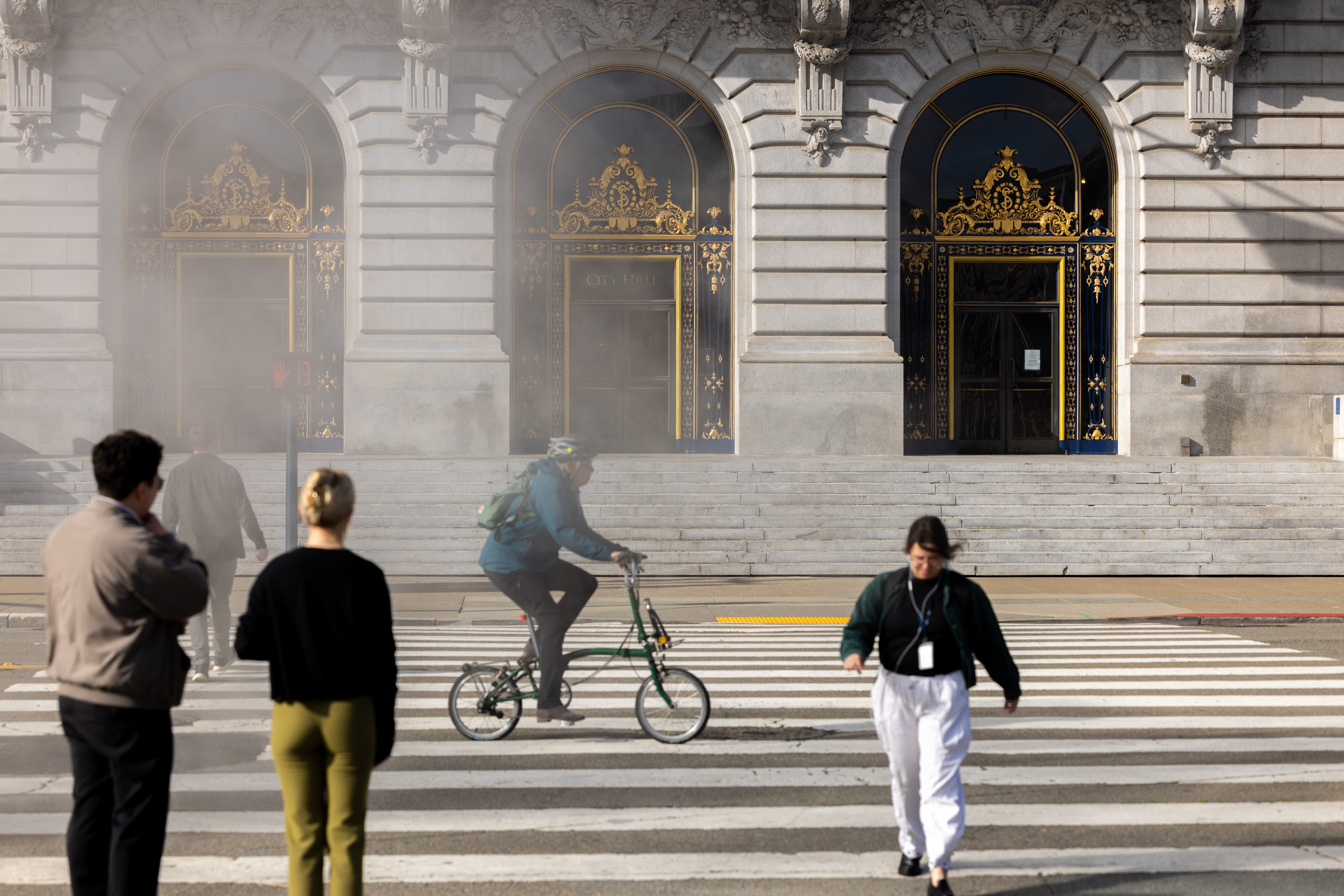 people riding bike on city hall