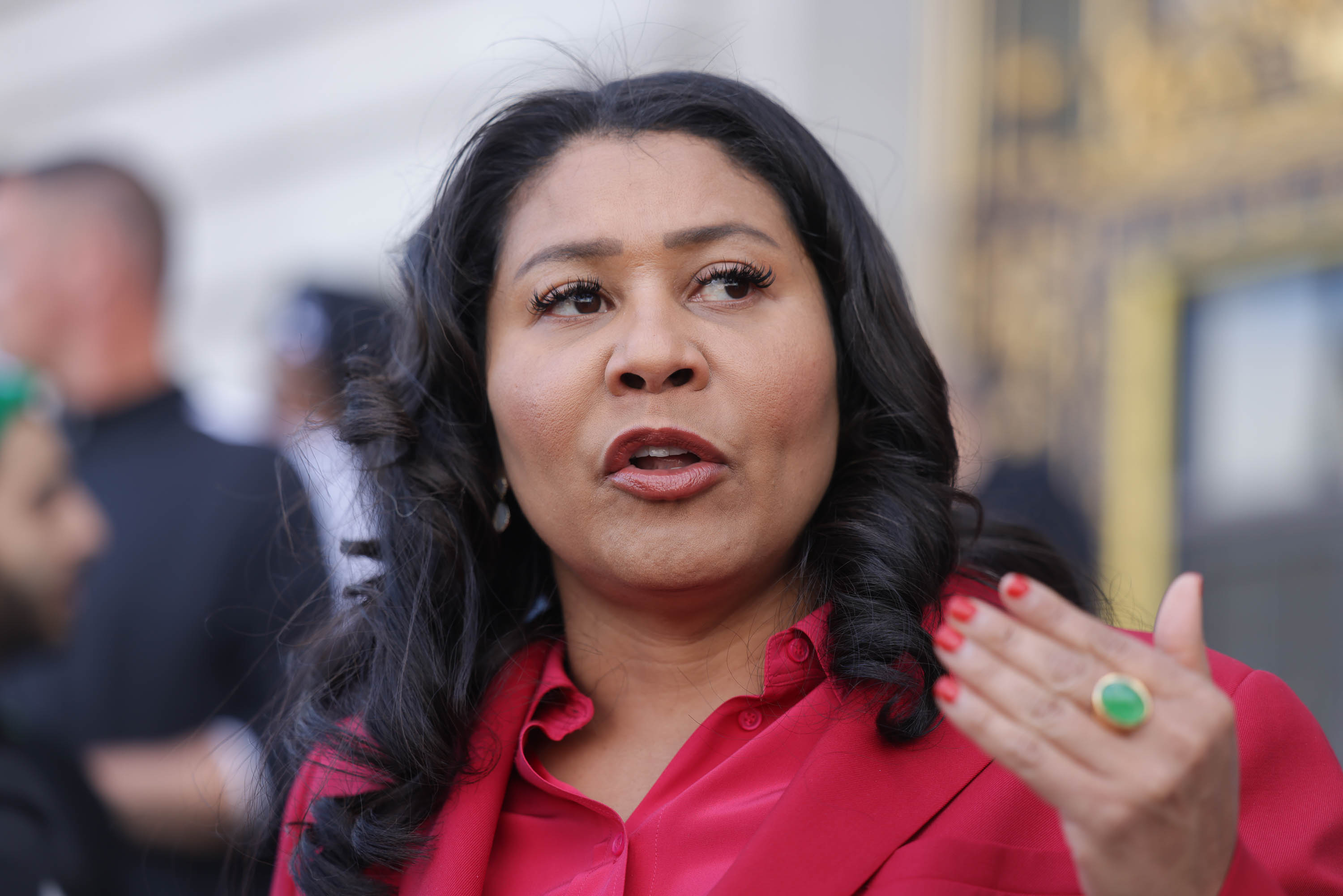 Woman in red collared shirt speaks