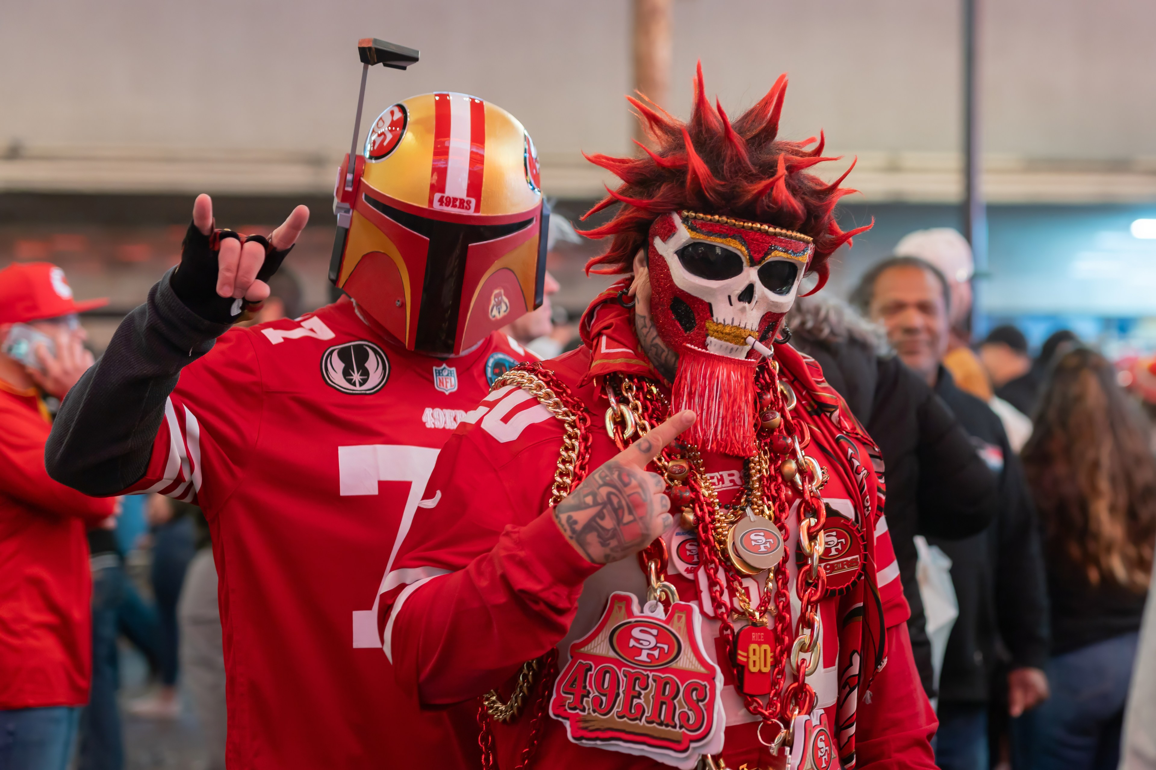 Fans wear red 49ers jerseys with masks