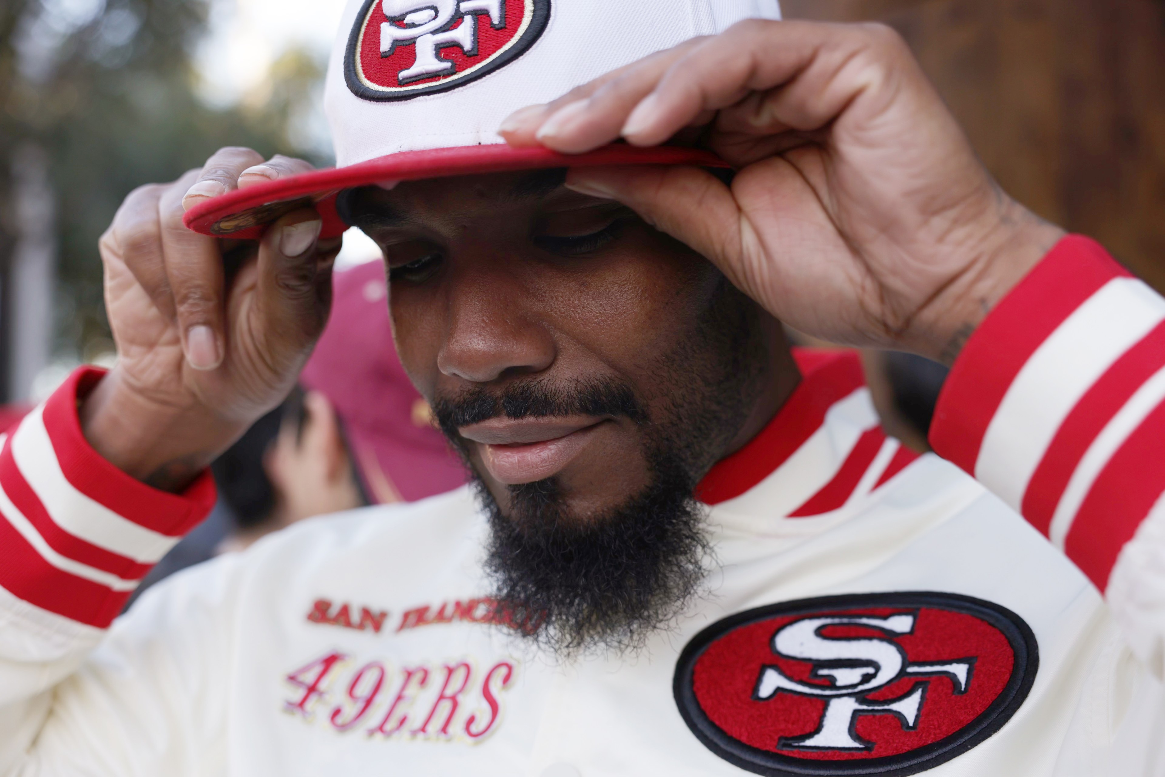 49ers fan tilts white and red cap