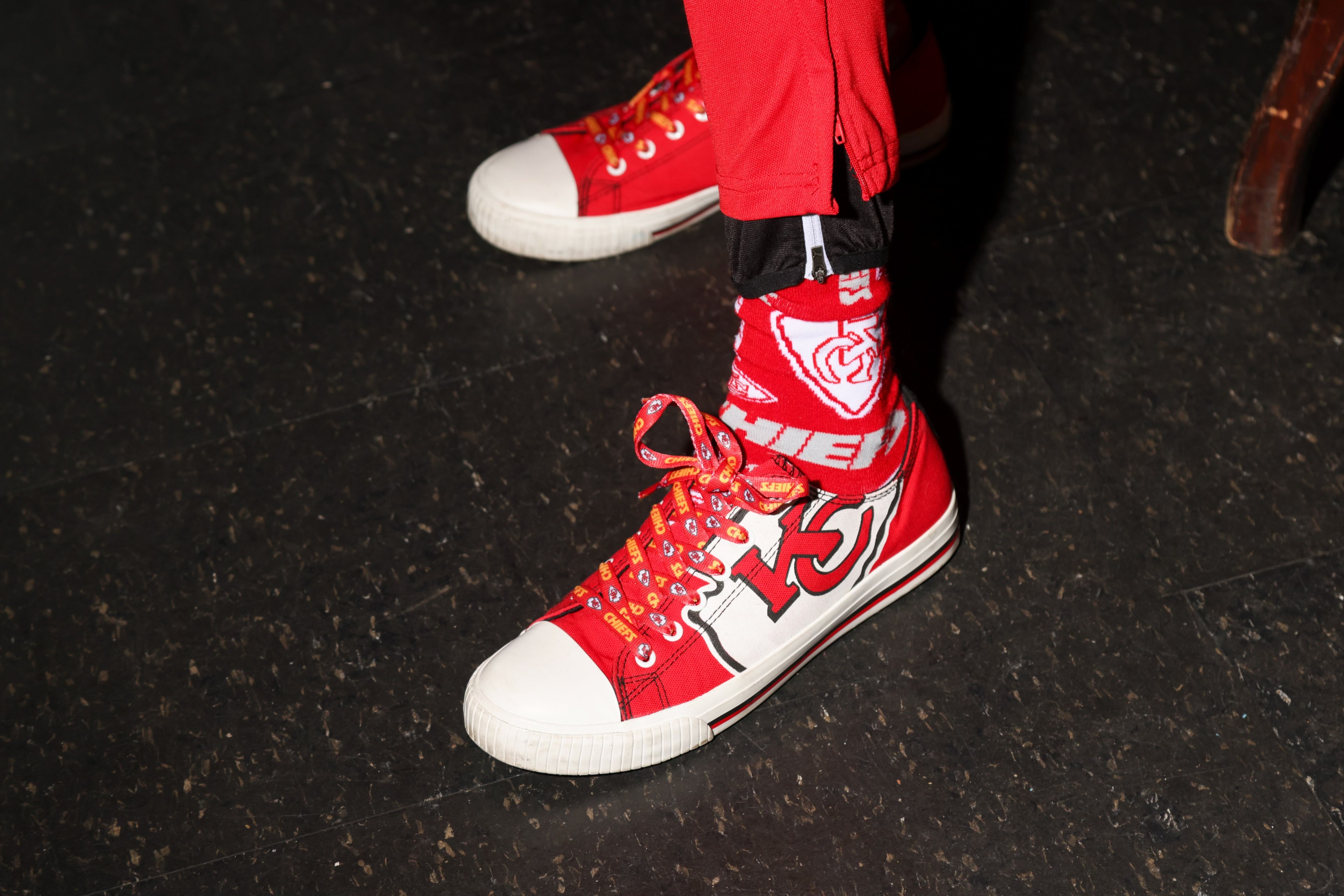 A fan sports white and red Kansas City Chiefs shoes and socks